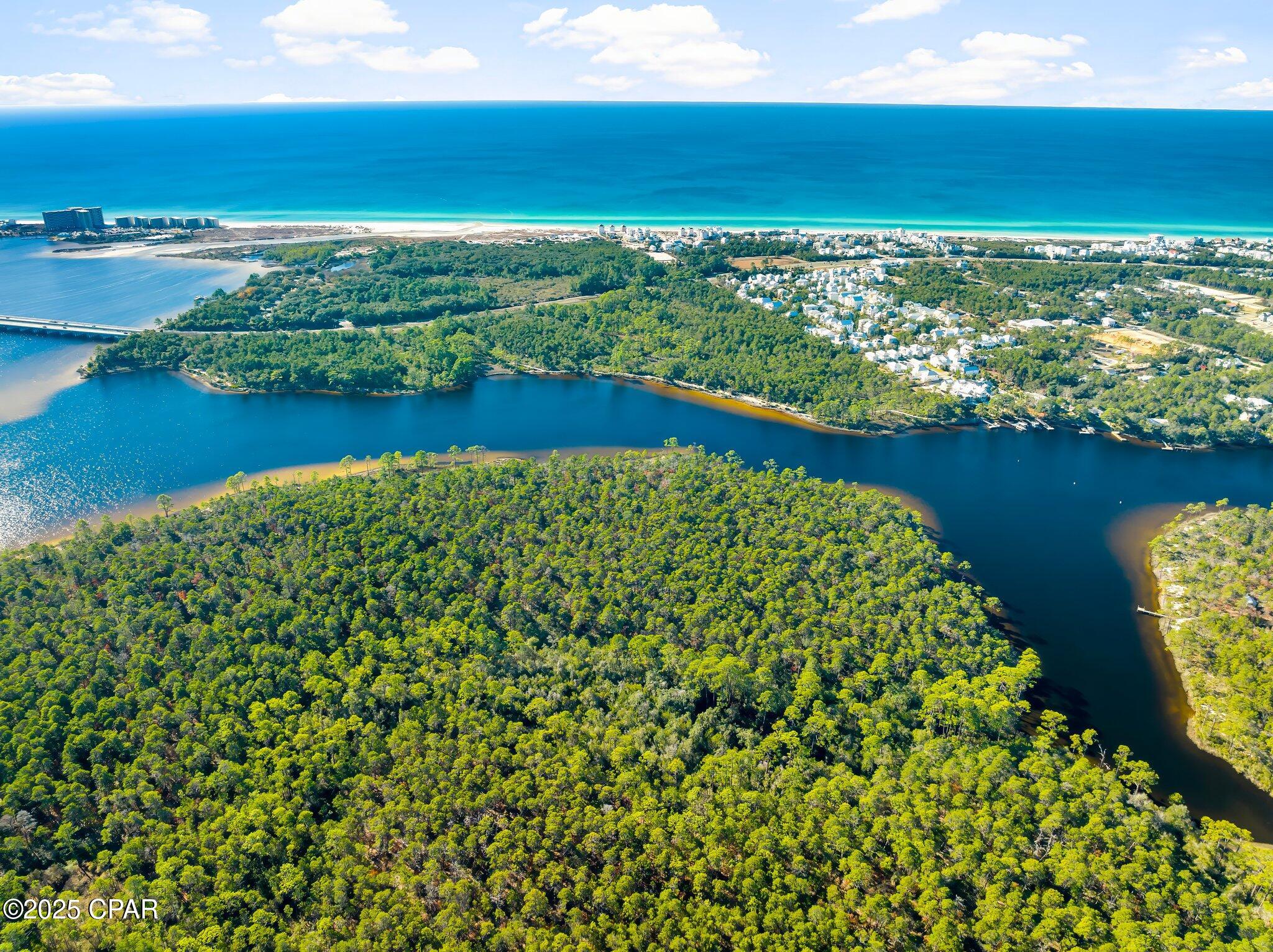 Rare Waterfront Opportunity: 5.58-Acre Powell Lake Parcel with ~300' Pristine Shoreline - Panama City Beach Area.

Tucked in a peaceful northwestern cove of Powell Lake--Florida's (and North America's) largest coastal dune lake at nearly 800 acres--this expansive 5.58-acre lot offers a truly one-of-a-kind canvas amid Northwest Florida's evolving landscape. Designated as an 'Outstanding Florida Waters' gem, the lake's brackish ecosystem supports exceptional boating, jet skiing, paddling, and wildlife viewing, with enhanced public access via Bay County's self-service kayak kiosk at the nearby boat ramp.

Boasting approximately 300 feet of direct, serene shoreline, this property delivers unmatched privacy and natural beauty--perfect for envisioning a custom waterfront retreat, eco-lodge, family compound, or long-term hold in a region where true lakefront acreage grows scarcer by the day.

Strategically positioned between the prestigious gated communities of Watersound Origins and Wild Heron, you're steps from resort-style amenities: Greg Norman-designed Shark's Tooth Golf Course, pools, nature trails, and more. Panama City Beach's west-end growth continues strong into 2026, with ongoing developments, new attractions (Topgolf, Pirates Voyage), shopping, and dining just minutes away--boosting lifestyle and investment upside.

Note on Access: This parcel is currently without legal road ingress/egress (water access only via the lake), a known condition reflected in the pricing and history. Ongoing regional dynamics--including potential future interest from major landowners like St. Joe Company--could open pathways for resolution, but buyers should conduct due diligence on access options, easements, or water-based use.

In a market where coastal dune lake shoreline is increasingly prized, this blank-slate waterfront rarity stands out for visionaries ready to explore its potential. Priced to reflect the unique circumstances--don't miss your chance to own a piece of this irreplaceable Emerald Coast treasure.