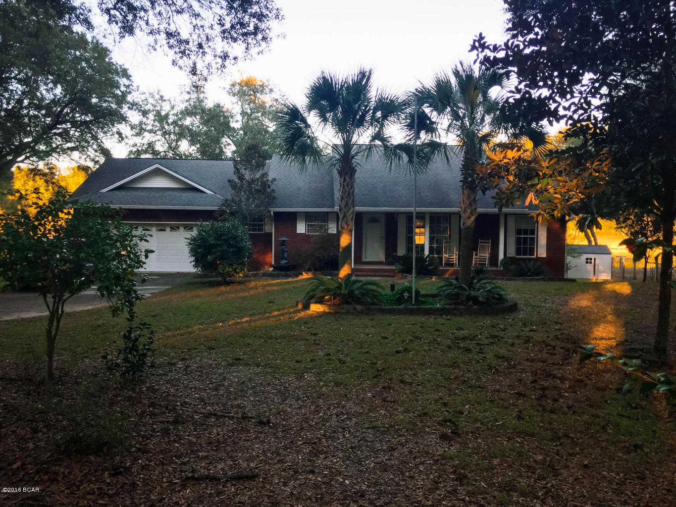 Reduced price, Owner says sell.  $5,000 floor allowance as carpet has been removed due to dog.  The quiet life is waiting for you just past Lake Merial and just outside of the Bay County line.  Nestled among the oak trees on a private lake in an all brick 3 bedroom two bath home on 1.89 acres. Enjoy your quiet retreat of pristine serenity.  This home boasts an open floor plan with breakfast bar, dining area and bay window.  The master bedroom suite and 2 quest bedrooms are a split plan.  Most rooms have a lake view.  The master bedroom features a large walk in closet and the master bath has double vanities of cultured marble.  This home has lots of charm and the neighborhood is lovely and nice and quiet.