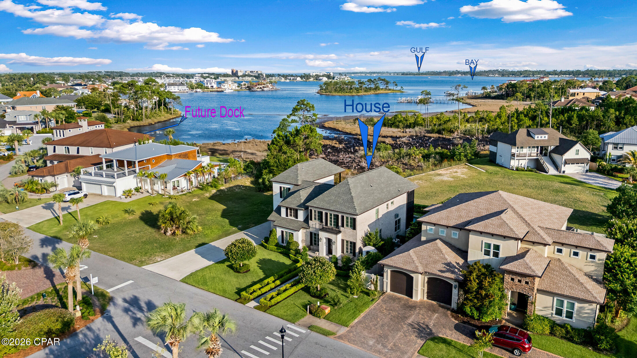 ****CURRENTLY IN THE PERMITTING PROCESS FOR A COMMUNITY DOCK.****
Each slip can hold up to a 42 ft sports fish convertible boat with outriggers.!****
Beyond the gas lanterns and handcrafted cypress doors lies a home where timeless architecture, waterfront living, and extraordinary craftsmanship come together in a way that is rarely found--and even more rarely offered.  Blending timeless French Provincial architecture with extraordinary craftsmanship, luxurious entertaining spaces, and an exciting future boating opportunity, this custom Bay Point estate is unlike anything else currently available.  Offering approximately 3,855 heated square feet (not including the separate auxiliary indoor kitchen), this remarkable residence features 5 bedrooms, 4.5 baths, two bonus rooms, a three-car garage, an English garden-inspired pool and spa, and breathtaking water views that are protected by neighboring waterfront setbacks.
*****FOR BOATING ENTHUSIAST, an exceptional opportunity awaits. After a two-year approval process, the owners are now in the permitting phase for a private community DOCK shared by only four neighboring properties, located just three lots away. The approved boat slip is designed to accommodate up to a 42-foot sportfish convertible with outriggers, creating an extraordinary lifestyle rarely available in Bay Point.

 In 2023, the home had undergone extensive improvements, including an approximately 900-square-foot addition, outdoor kitchen, a newer roof, three newer HVAC systems, and in 2026, the owners added a newly installed steam shower, fresh interior paint, and updated brick paver flooring.
From the moment you arrive, the home's architectural character is unmistakable. A solid wood front door welcomes you beneath three glowing gas lanterns, framed by custom cypress shutters, handcrafted cypress garage doors, decorative wrought-iron fencing, elegant balconies, and beautifully manicured English garden landscaping. Inside, every room reflects a level of craftsmanship that is increasingly difficult to find. Hickory hardwood floors, reclaimed century-old solid wood doors, antique rim-lock hardware, extensive custom millwork, soaring ceilings reaching approximately 17 feet, exposed brick accents, tongue-and-groove heart pine ceilings, and designer lighting from Restoration Hardware and Visual Comfort combine to create a home filled with warmth, sophistication, and timeless elegance.  Designed for both everyday living and unforgettable entertaining, the outdoor living area features a resort-style pool and spa surrounded by mature landscaping and an impressive built-in brick outdoor kitchen complete with a gas grill, gas burner, industrial flat-top griddle, and an adjacent auxiliary indoor kitchen featuring a full-size refrigerator, commercial ice maker, custom cabinetry, and stainless sink.The chef's kitchen is equally impressive, showcasing a premium Thermador appliance package including a built-in refrigerator/freezer, 48-inch range, matching dishwasher, brand-new wine refrigerator, and two separate ice makers. The thoughtfully designed floor plan offers two luxurious primary suites, three additional bedrooms, four-and-a-half baths, and two versatile bonus rooms. The primary suite is a true retreat featuring a spectacular custom-designed walk-in closet with automatic cabinet lighting, built-in cabinetry, and a hidden speakeasy entrance. Throughout the home, bathrooms are appointed with marble and porcelain finishes, three classic clawfoot soaking tubs, dramatic vaulted ceilings, and a spa-inspired steam shower.  Hidden throughout the residence are details that make this home unforgettable--from two concealed speakeasy rooms to a formal dining room with wet bar, whole-home surround sound wiring, surveillance system, plantation shutters, motorized shades, and a rare William IV / Early Victorian cast-iron fireplace insert imported from London and dating to approximately 1830s. This is more than a home--it is a residence that has been thoughtfully curated over the years with exceptional attention to detail, timeless materials, and architectural authenticity. Every space has been designed to create an atmosphere that feels both luxurious and welcoming, offering an extraordinary opportunity to own one of Bay Point's most distinctive custom water view properties.