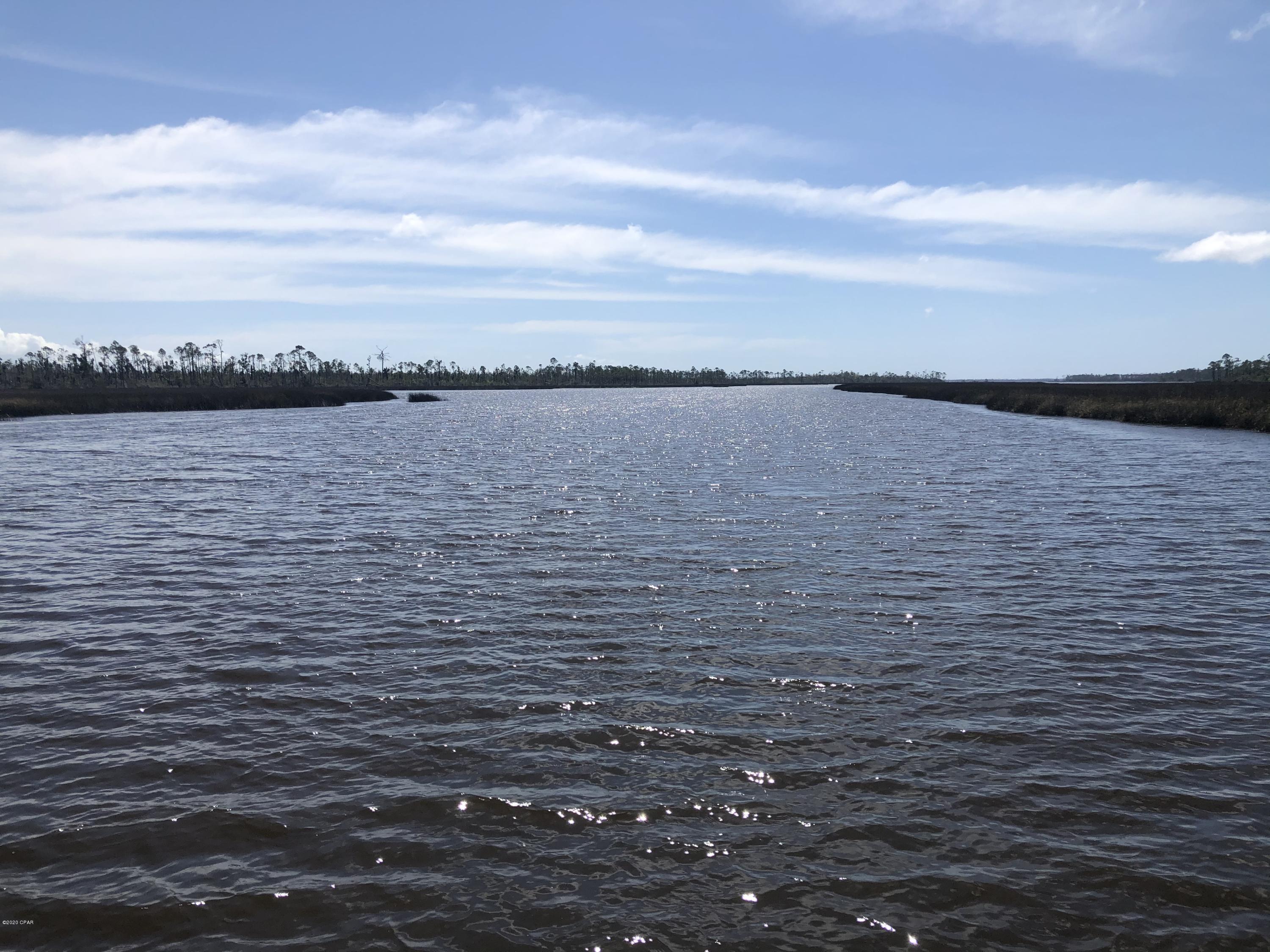 This incredible 86.81 acres vacant land sits on a high bluff some 20-30 feet above the water.  Aprox. 400 feet waterfront.  What an incredible location to build your own private and fascinating estate set amid privacy, you could even have horses here, and the water depth just right off the shore is an incredible 12 ft deep, so bring your yacht up into this private and protected cove!  Old boat dock on property - unsure of condition. 

 Paved public boat ramp nearby.  Another 425 feet of waterfront and 3.73 acres can be added to this parcel for additional dollars if someone wants more water frontage.