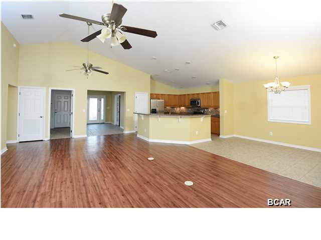 Just wait until you see THIS 3BR/2BA Palmetto Trace home! When you first enter, there is a bonus room that can be used for an office, den, play room or even a 4th bedroom so it really is like owning a 4 bedroom house. The open floor plan makes everything feel roomy and spacious with the kitchen, dining area and living room all together under high ceilings. There are upgrades everywhere, maybe most noticeable in the kitchen which features stainless steel appliances, under cabinet lighting, a glass tile backsplash and raised panel cabinets. Granite counter tops and gorgeous floors, really add to the upscale feel while all of the carpet in the rest of the home is BRAND NEW. The master suite is oversized with a garden tub, dual vanities and a separate shower in the master bathroom and