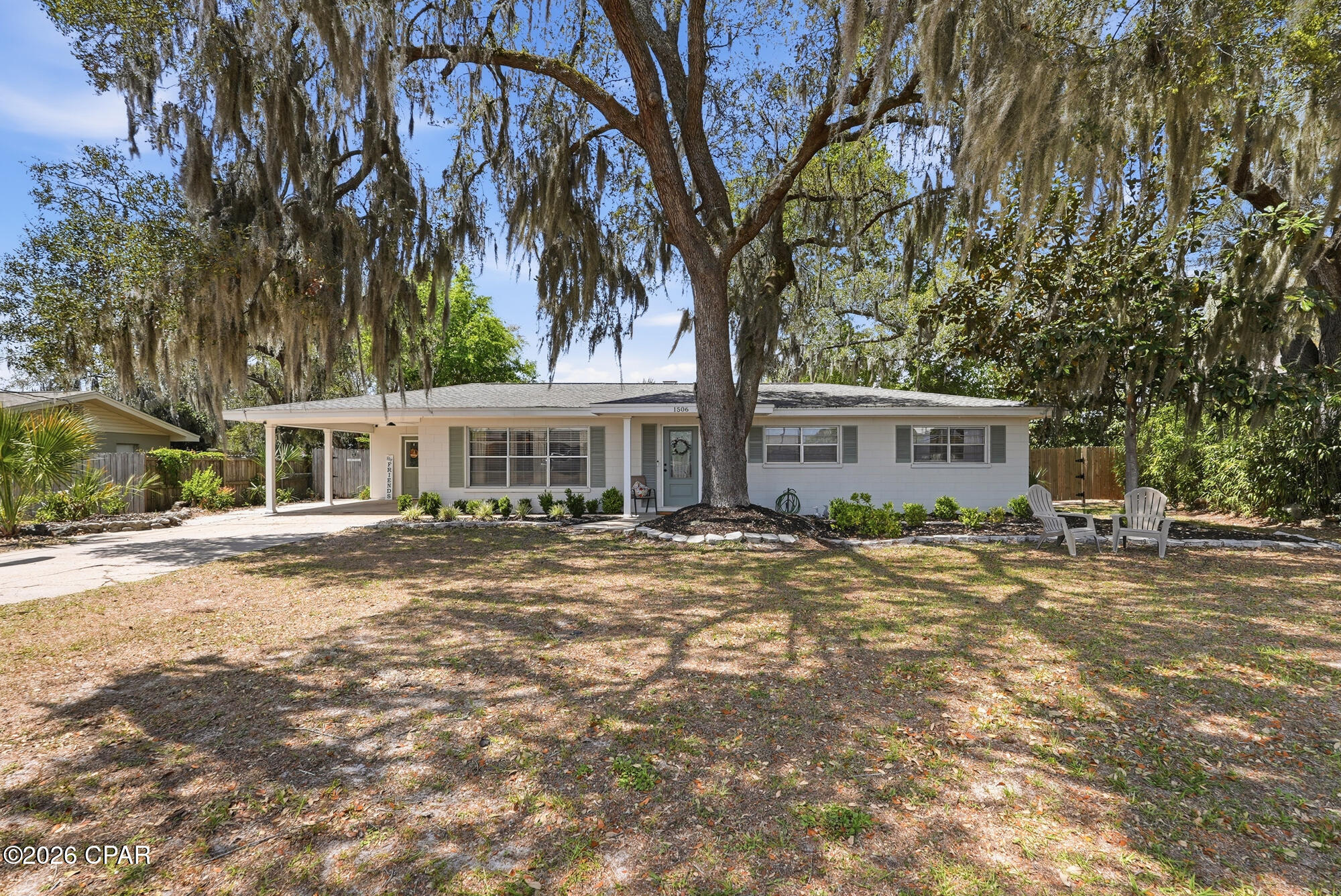 CURRENTLY UNDER CONTRACT, SELLER WILL CONSIDER BACKUP OFFERS. Quaint Florida cottage in the heart of Lynn Haven surrounded by live oaks and Spanish moss, magnolias and palm trees that canopy the home.. This charming Southern cottage is light and airy and has been completely updated. Grab your golf cart and cruise to the bay or to one of the local parks. This is a 3 bedroom 2 full bath home that is perfect for the first time home owner or a family looking to downsize. The home has new ceramic tile flooring, a remodeled kitchen and lots of other amazing updates. The family room is cozy and spacious. The eat in kitchen has a wood burning fireplace.  The home features a large laundry room right off the kitchen and carport making it easy for groceries and additional storage. The bedrooms are big and offer lots of natural light. This charming home has a 
100 x 150 oversized lot with plenty of room for outdoor entertaining and tons of privacy. The entire backyard is fenced-in with large gates on both sides. There is a fire pit in the back that coveys with the home. The HVAC was replaced in 2023 and the roof was replaced in 2019. THIS HOME IS NOT in a FLOOD ZONE and there is NO HOA. One of the best features is the LOCATION. You are minutes to some of the top schools in Bay County and minutes to all of the best grocery stores, and restaurants. Lynn Haven is one of the most popular communities with plenty of parks, a public boat ramp, FREE concerts and so much more. The central location of the home makes it easy and fast to get to the beautiful beach, the airport, Tyndall Air Force Base and the Navy Base. Make an appointment to see this cozy cottage TODAY and you will feel AT HOME from the minute you walk in the front door!