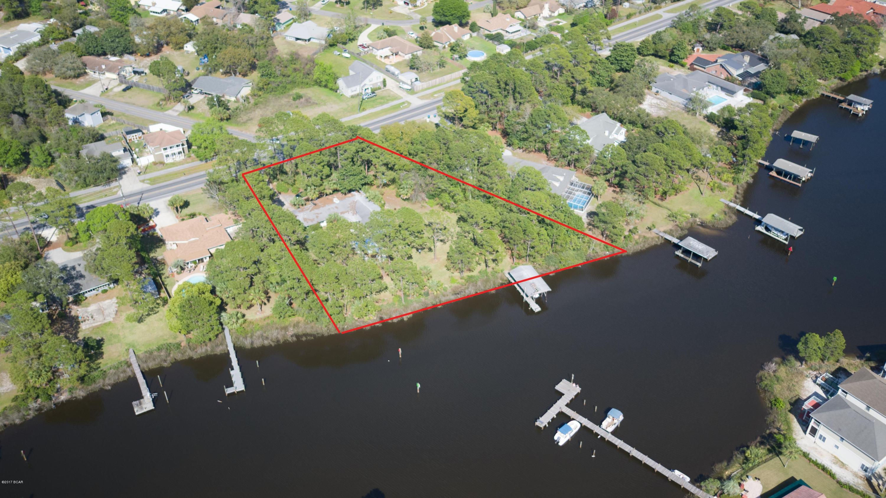1.387 Acres of Waterfront land directly on the Lagoon!! Over 300 Ft of Lagoon Frontage. Would make a great small Lagoon-front community for developer or an amazing home site Directly on the Water with access to nearby Shell Island, . This property has an existing home on-site with little value. Property is in an excellent location. Check out the pictures to see more about this unique property. All measurements are approximate, buyer to verify.