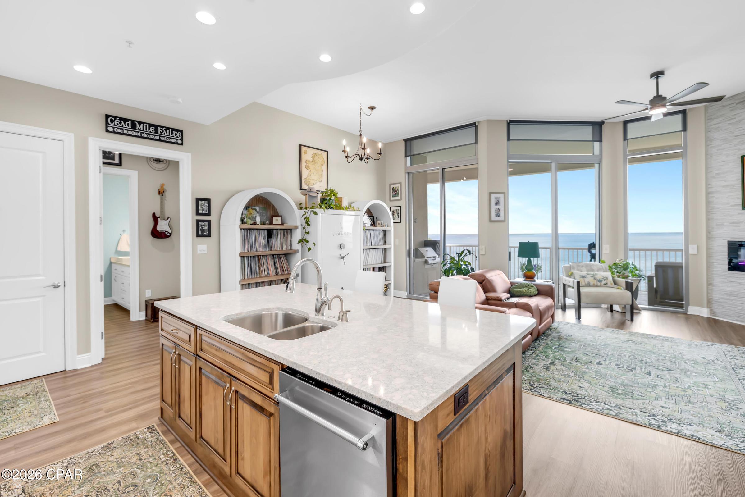 BAY VIEWS. 12-FOOT CEILINGS. PRISTINE CONDITION. 

Welcome to Marina Landing Unit 1504 in Panama City Beach, Florida, a completely remodeled waterfront residence where the views take center stage and absolute pride of ownership is reflected in every detail. From the living room, kitchen, and both bedroom suites, this 15th-floor residence captures sweeping views of the Bay, the Hathaway Bridge, passing boats, and some of the most beautiful sunrises Panama City Beach has to offer.
Located on the 15th floor, this two-bedroom, two-bathroom residence features two private suites and rare 12-foot ceilings available only on the 15th floor and penthouse level. Floor-to-ceiling windows and sliding glass doors showcase panoramic views of the bay, the Hathaway Bridge, and the boats passing below, while custom remote-controlled blinds add convenience and privacy throughout the home.
New flooring runs throughout the entire residence, which has been extensively updated from top to bottom. The kitchen features an extended island with exceptional storage, lifetime-warranty Cambria countertops, soft-close cabinetry and drawers, a convection oven, and an on-demand hot water faucet. Matching Cambria countertops continue into both bathrooms, creating a consistent, well-appointed finish throughout the home.
The living room includes an electric fireplace and opens to a spacious waterfront balcony. Marina Landing is one of the few condominium communities with a built-in electric grill on the balcony, making it easy to enjoy outdoor cooking while taking in the views of the bay.
The primary suite features a custom walk-in shower with dual shower heads, a glass enclosure, and additional storage. Every closet has been upgraded with custom Closets by Design systems, including the laundry area and the exterior storage closet located directly outside the front door.
Additional improvements include a high-efficiency HVAC system and condenser, EcoBee Wi-Fi thermostats, Halo UV light and ionizer system, 47-gallon water heater, all installed in 2025, LED temperature-adjustable recessed lighting, an all-in-one washer and dryer, built-in Hollon mini safe, and modern color-changing balcony lighting.
Conveniently located near the elevator bank, Unit 1504 includes an assigned parking space along with ample guest parking within the garage.
Marina Landing offers covered parking, a hot tub, community pool, fitness center, meeting room, owners' lobby, grocery and luggage carts, and direct access to a marina lifestyle. The community is pet friendly, subject to association rules and restrictions.
The HOA fee is $2,928 per quarter, and association fees include water, sewer, garbage, building insurance, basic cable TV and Wi-Fi, pest control, common area maintenance, and management. On-site maintenance is available from 6 AM to 6 PM.
A transferable home warranty is included for the new owner, adding another layer of confidence to this already extensively updated waterfront residence.
All information is believed accurate but not guaranteed; buyer to verify if important.
