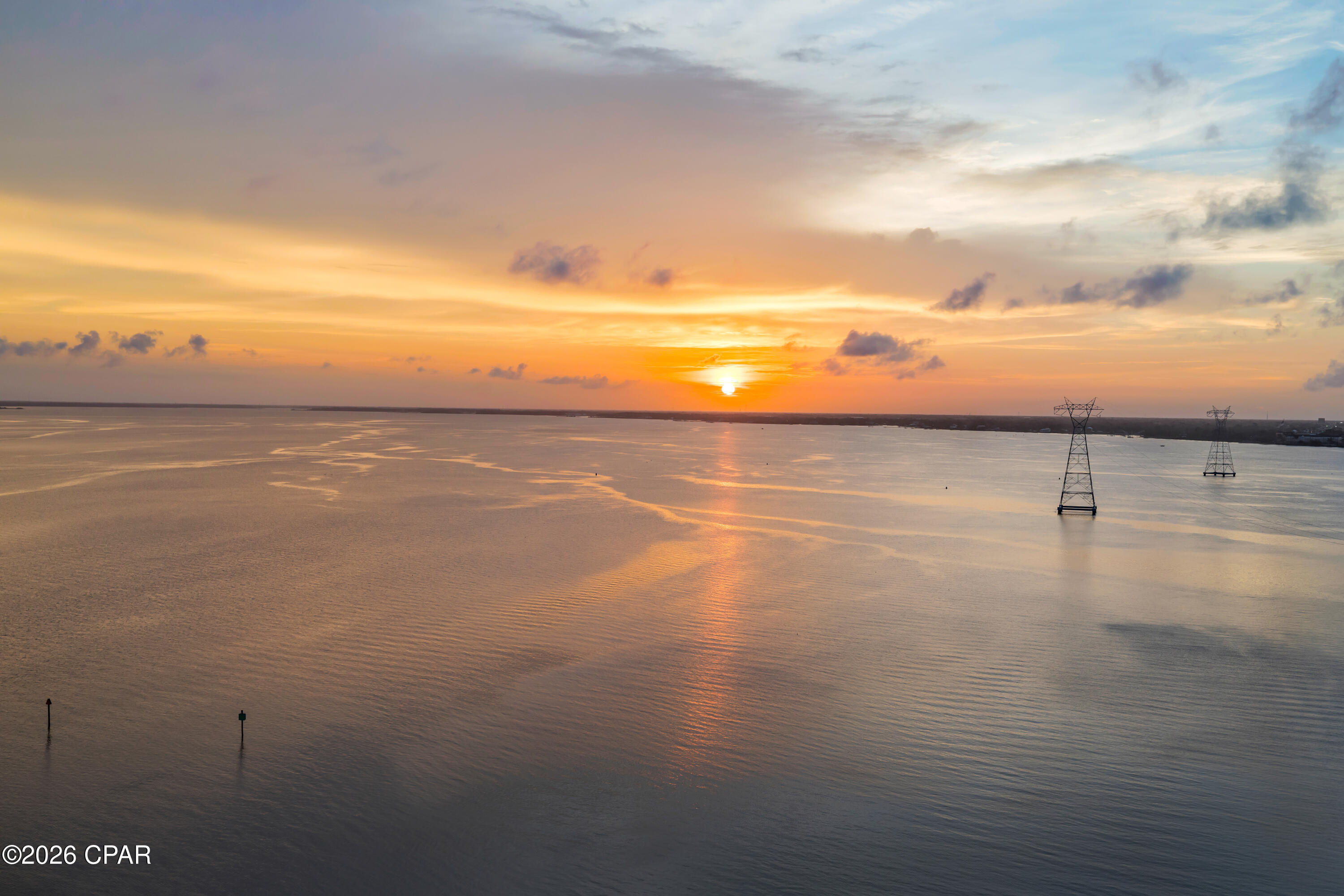 BAY VIEWS. 12-FOOT CEILINGS. PRISTINE CONDITION. 

Welcome to Marina Landing Unit 1504 in Panama City Beach, Florida, a completely remodeled waterfront residence where the views take center stage and absolute pride of ownership is reflected in every detail. From the living room, kitchen, and both bedroom suites, this 15th-floor residence captures sweeping views of the Bay, the Hathaway Bridge, passing boats, and some of the most beautiful sunrises Panama City Beach has to offer.
Located on the 15th floor, this two-bedroom, two-bathroom residence features two private suites and rare 12-foot ceilings available only on the 15th floor and penthouse level. Floor-to-ceiling windows and sliding glass doors showcase panoramic views of the bay, the Hathaway Bridge, and the boats passing below, while custom remote-controlled blinds add convenience and privacy throughout the home.
New flooring runs throughout the entire residence, which has been extensively updated from top to bottom. The kitchen features an extended island with exceptional storage, lifetime-warranty Cambria countertops, soft-close cabinetry and drawers, a convection oven, and an on-demand hot water faucet. Matching Cambria countertops continue into both bathrooms, creating a consistent, well-appointed finish throughout the home.
The living room includes an electric fireplace and opens to a spacious waterfront balcony. Marina Landing is one of the few condominium communities with a built-in electric grill on the balcony, making it easy to enjoy outdoor cooking while taking in the views of the bay.
The primary suite features a custom walk-in shower with dual shower heads, a glass enclosure, and additional storage. Every closet has been upgraded with custom Closets by Design systems, including the laundry area and the exterior storage closet located directly outside the front door.
Additional improvements include a high-efficiency HVAC system and condenser, EcoBee Wi-Fi thermostats, Halo UV light and ionizer system, 47-gallon water heater, all installed in 2025, LED temperature-adjustable recessed lighting, an all-in-one washer and dryer, built-in Hollon mini safe, and modern color-changing balcony lighting.
Conveniently located near the elevator bank, Unit 1504 includes an assigned parking space along with ample guest parking within the garage.
Marina Landing offers covered parking, a hot tub, community pool, fitness center, meeting room, owners' lobby, grocery and luggage carts, and direct access to a marina lifestyle. The community is pet friendly, subject to association rules and restrictions.
The HOA fee is $2,928 per quarter, and association fees include water, sewer, garbage, building insurance, basic cable TV and Wi-Fi, pest control, common area maintenance, and management. On-site maintenance is available from 6 AM to 6 PM.
A transferable home warranty is included for the new owner, adding another layer of confidence to this already extensively updated waterfront residence.
All information is believed accurate but not guaranteed; buyer to verify if important.