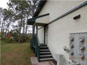 Waterfront Town Home located on Grand Lagoon. Enjoy wonderful sunsets , the master bedroom is located on the 2nd floor with balcony overlooking the Lagoon, master has dressing area , Jack and Jill bath is between the master and 2nd bedroom. Washer and Dryer closet located on the 2nd floor. Living room/ dining area located on the 1st floor. Living room has build-in bookcase/entertainment center. Sliding doors off the living room also access the covered porch which also overlooks Grand Lagoon. There is a storage closet on the covered porch. This is a great value for water front. Call today to schedule an appt.