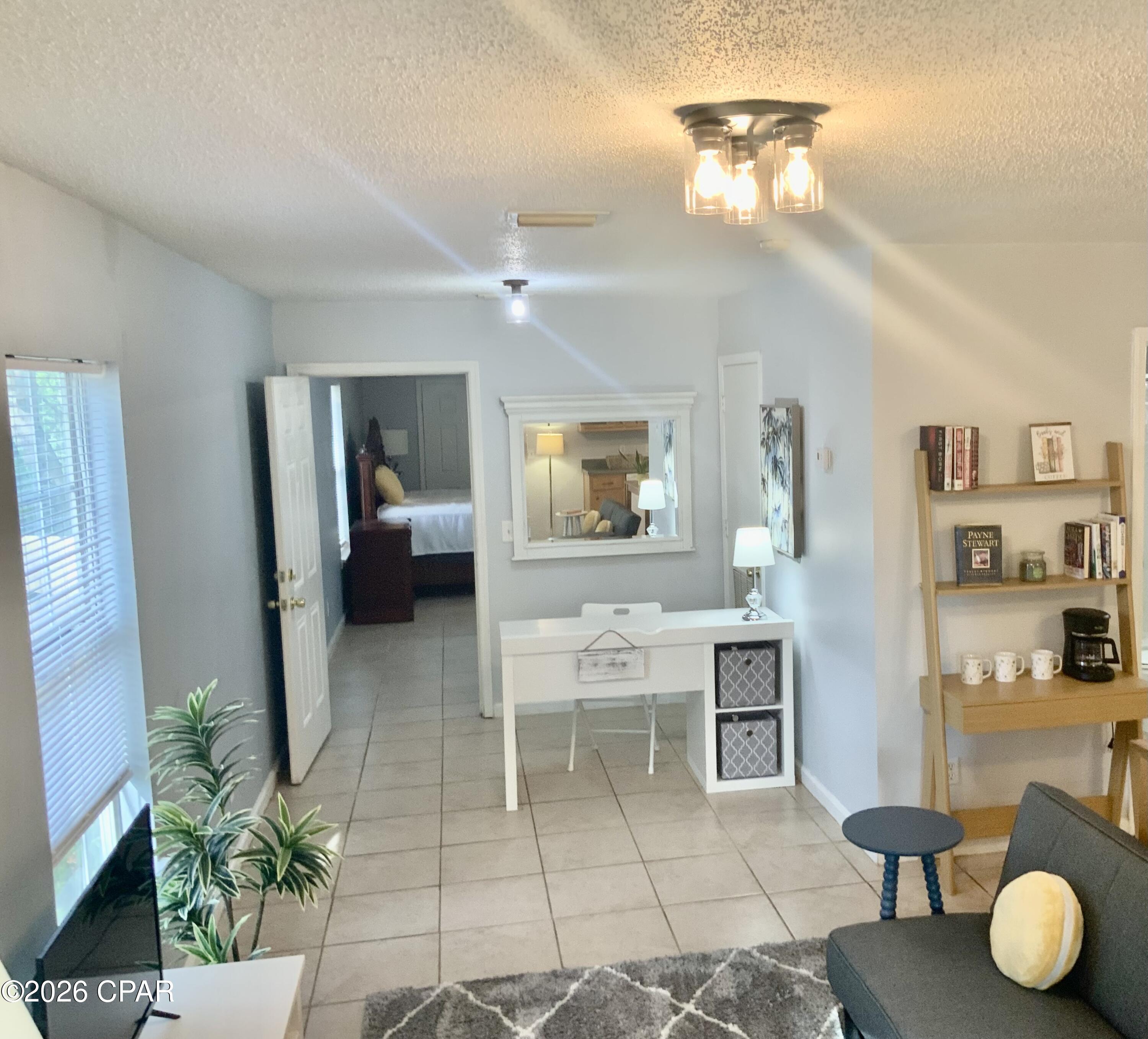 Irresistible Florida COTTAGE CHARM meets modern convenience in historic Saint Andrews! Located in the Oak Hill community of Saint Andrews, this is THE PICTURESQUE SETTING you've been looking for! Need a quiet hideaway? Looking for roots for your small family? Require an OFFICE SETTING in your home? Maybe an affordable rental property! This thoughtfully-designed, one bedroom two bath home maximizes every square foot offering a seamless open floor plan perfect for coastal living.
The design offers a flexible living area that will accommodate the occasional guest, a dining area with a new counter height table to serve as both a breakfast bar AND additional prep space,  AND a well-equipped kitchen. There are two FULL bathrooms... one with a shower; one with a tub.  The LARGE BEDROOM is furnished with a KING bed, two large nightstands, and an armoire. Besides the full bathroom with shower in the bedroom, there is also a closet already equipped with Maytag washer and dryer, and an additional closet. Taking care of business at home? An OFFICE ALCOVE is neatly tucked between the bedroom and the living area and could easily be partitioned off for additional privacy. With its FENCED corner location and new road surfaces and sidewalks being placed, it's a pleasant walk to Saint Andrew Bay.  Public, private, charter, and specialty school options are all nearby. The cottage is located 15 minutes to a Panama City Beach public parking lot...and it's off to the SUGAR SHORE and emerald waters of world renowned beaches! There is no HOA so NO HOA fees or new buyer fees or contributions required. This low maintenance cottage is 2005 construction and sits in the shade amongst picturesque tilted oaks on a pretty corner lot. It can be available with some furniture.