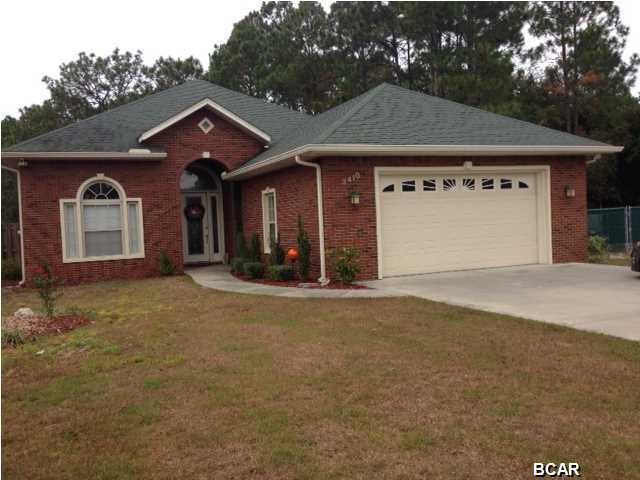 Beautiful executive home in desirable Lynn Haven,close to town and Tyndall AFB. This home features an all brick exterior, with a beautiful 10' leaded glass door entrance. 12' ceilings throughout, tile and hardwood grace this home. The living room features a deluxe home entertainment package that allows for stereo/TV sound in every room. This amazing home also features a panel patch that provides internet and cable to the entire house inside and out! Office with French doors could be formal dining room! Master bath spa tub and sinks had new high-end deluxe Brizo fixtures. Open floor plan that is awesome for entertaining. Beautiful screen room that encloses the pool and patio area. Patio area features doggie door to run, as well as cable and stereo hookups for outdoor entertaining.