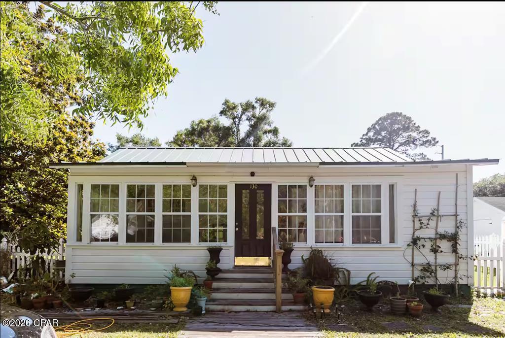 OPTION to purchase lot 3 (Subject B) in addition to the subject property listed (A) as pictured. This century old vintage Floridian cottage made of cedar is perfect for anyone who enjoys strolling easily to the unique shops of downtown Apalachicola; as it is only one mile from all the wonderful restaurants, boutiques, collectable markets, and candy shops Apalach has to offer! This home located in the historic district has withstood the test of time (and storms). What's more? The property is within a 1/2 mile of the water! The home is one level, making it easily accessible to all. Like any true Floridian home, it has a beautiful sunroom for basking in natural light whilst reading your favorite novel or sipping on a warm cup of coffee. The main house features a large eat-in kitchen with an abundance of counter space and a large pantry. The primary bedroom boasts an en suite bath, with a tub, along with a walk-in closet. The second bedroom has direct access to the hall guest bath. If you enjoy the character and quirkiness of historic-style homes, look no further! Your sunny, Florida gem is waiting on you.. and maybe your favorite pet, too! Embrace the essence of coastal living with this stunning home that captures the spirit of historic Apalachicola.