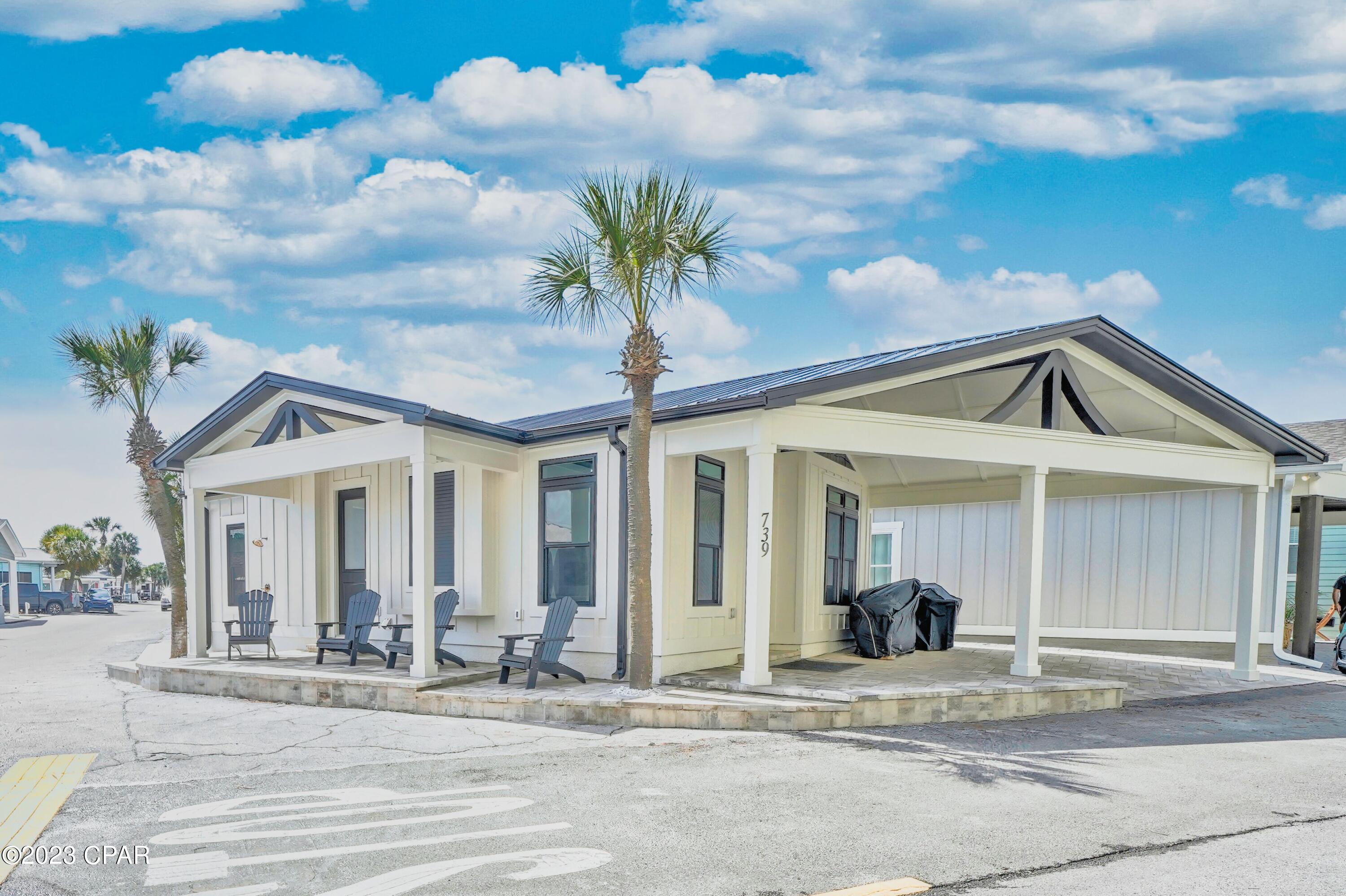 CURRENTLY UNDER CONTRACT, SELLER WILL CONSIDER BACKUP OFFERS
Potential investment powerhouse new to the market! Beautifully designed 3-bedroom, 2-bath coastal home located within the gated, golf cart community of Venture Out in Panama City Beach. This light-filled home features an open floor plan with soaring vaulted ceilings and high-end finishes throughout. The spacious living area showcases custom shiplap accents, built-in cabinetry, floating shelves, and abundant recessed lighting, creating a bright and inviting atmosphere.

The chef's kitchen is thoughtfully designed with crisp white cabinetry, quartz countertops, stainless steel appliances, a large center island, and an eye-catching designer tile backsplash. Stylish pendant lighting and modern hardware enhance the home's upscale coastal aesthetic. A dedicated dining area sits just off the kitchen, offering natural light and seamless flow for entertaining.

Luxury vinyl plank flooring runs throughout the main living spaces, complemented by neutral tones and coastal textures. The open layout provides a comfortable and functional design for both everyday living and hosting guests.

Venture Out is a gated beachfront community offering private beach access, security, and a wide range of amenities, all just minutes from shopping, dining, and entertainment along Panama City Beach.


This home blends timeless coastal charm with modern design in one of Panama City Beach's most sought-after communities.
