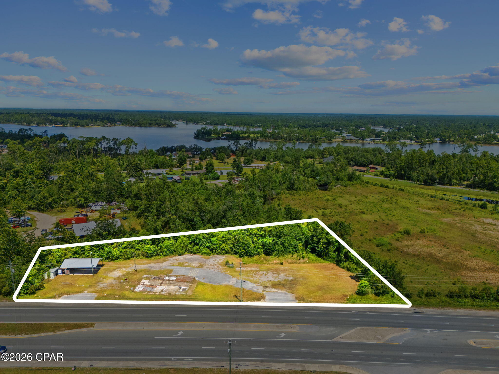 1.586 ACRES | C-3 GENERAL COMMERCIAL | APPROX. 475 FT OF HIGHWAY FRONTAGE | AADT 34,000 | TWO EXISTING DRIVEWAY ACCESS POINTS | 36X24 POLE BARN WITH POWER OUTLETS

Positioned along the highly traveled Highway 77 corridor in Panama City, this 1.586-acre C-3 General Commercial parcel offers an excellent opportunity for investors, developers, and business owners seeking visibility, accessibility, and long-term commercial potential. With an AADT of approximately 34,000 vehicles and an estimated 475 feet of highway frontage, this property provides strong exposure in a growing commercial area. Whether you are looking to establish a new business location, expand your commercial portfolio, or secure a high-visibility investment property, 6937 Hwy 77 offers the location, frontage, and flexibility to support a variety of commercial uses.

Located directly across Highway 77 from Tractor Supply, the site benefits from established traffic patterns and nearby commercial activity. The property also features two existing driveway access points from the highway, allowing for convenient ingress and egress and adding functionality for future commercial use or redevelopment.

An existing 36x24 pole barn remains on-site, offering added utility and potential use during future development or site planning. Power outlets have also been run to the pole barn, providing the potential for future power connection and added functionality, subject to buyer verification. Portions of a slab remain from a previous building that was on-site prior.

With C-3 General Commercial zoning, the property allows for a wide range of commercial possibilities, making it well suited for retail, office, service-based business, redevelopment, or a strategic land hold. The combination of highway frontage, traffic count, acreage, existing access points, site improvements, and commercial zoning creates a compelling opportunity in one of Panama City's active growth corridors.

Buyer to verify all zoning, land use, utilities, power availability, dimensions, access, and intended development plans.