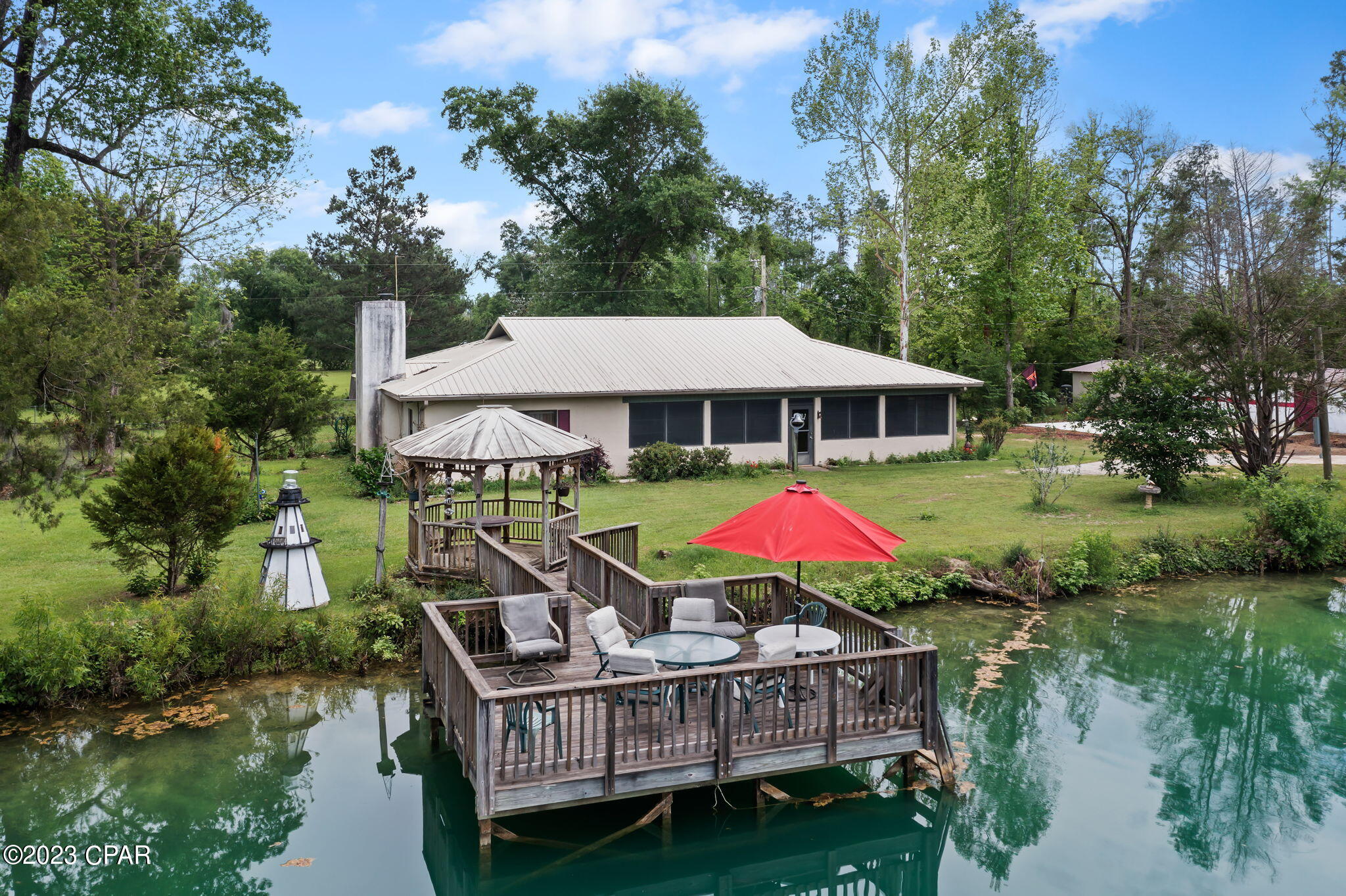 Come see this ''Mini Ranch'' with all of the extras!!!!  A spacious 3BR/2BA home sits behind a large, stocked with catfish, pond. The pond has a gazebo, that you can relax under while catching your lunch/dinner, a dock and an aerator to keep a healthy habitat for the fish.
The home has a extra large closed in front porch with windows and tile floors, living room w/ wood burning heater, built-in bar with a sink, extra-large kitchen, oversized bedrooms, and master bath has a handicap shower. Updates include a Culligan water softener at kitchen sink, metal roof, toilets, and a HCAV unit.  Outside boasts chain link fencing in the back yard, fencing with corral panels, a horse barn w/ 4 stalls, tack room and feed room, and there is a separate storage building/shop for a tractor etc all on10 beautiful acres.