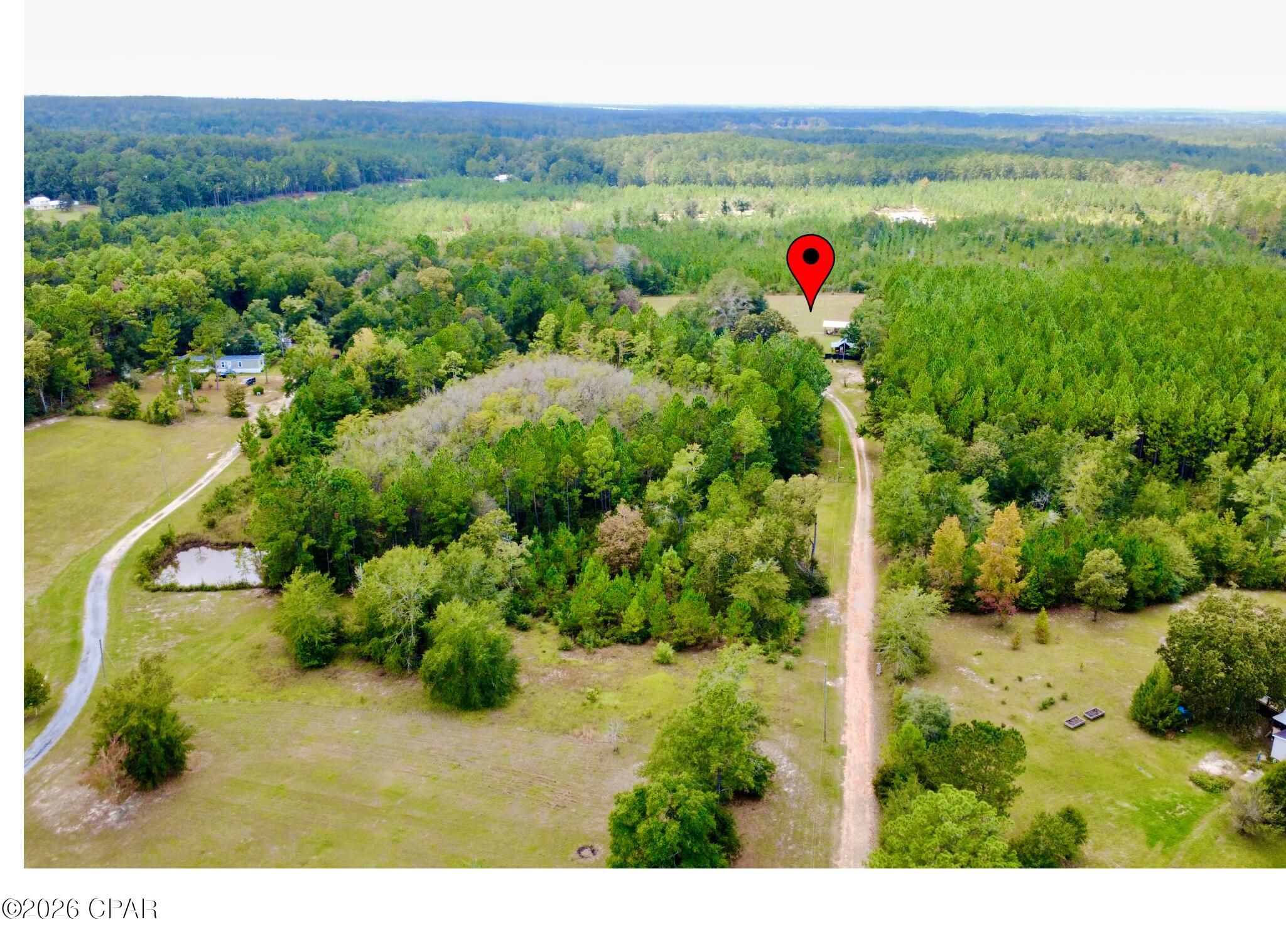 Discover the perfect blend of privacy, functionality, and country living on this beautiful 5.5-acre property in Wausau, Florida. Tucked away behind a long private driveway, this mostly fenced parcel is already equipped with power, well, septic, and multiple outbuildings, making it ideal for a homesite, mini farm, homestead, or weekend retreat. Property features a large pole barn, additional storage buildings, and plenty of cleared space while still offering a peaceful natural setting. Conveniently located with easy access to Chipley, Sunny Hills, Holmes Creek, and just a short drive to Panama City Beach. Bring your animals, equipment, RV, or future home plans and make this versatile property your own. No HOA. Endless possibilities with improved land already in place.