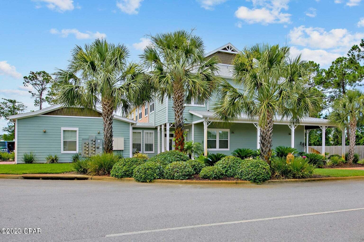 Immediate occupancy. Let's make a deal. ONE OF THE MOST UNIQUE CONDO AREAS YOU WILL FIND!  This beautiful Floridian style  townhouse is an end unit which rarely becomes available.  Huge wrap around porch for lounging and growing your tropical plants.  Inside you will feel the coastal elegance immediately.  Amazing top of the line light fixtures, unique tile flooring, wet bar, and so much room for your beautiful furnishings.  All bedrooms have their own bathroom.  Enjoy the cozy balcony from your master bedroom & catch a sunset.  Two car garage w/attic too.  Amenities galore at Island Reserve.  You won't believe the island style pool with three waterfalls.  There is also a hot tub, splash pad for the kidos, indoor pickleball in the gym, basketball court, fitness center, community room with pool table, theater room and social get togethers for meeting your neighbors.  Food trucks scheduled monthly, water aerobics and more!  Forget the crowds and enjoy the laid back lifestyle at Island Reserve.  The beach is approx. 2 miles away, lot's of shopping & restaurants nearby including Pier Park which is 5 miles away.  Emergency care right around the corner.  All bedrooms are upstairs with their own private bathroom.  Half bath downstairs.  GATED COMMUNITY.  Now vacant & move in ready!  This would also be a great money making LONG TERM rental property too!