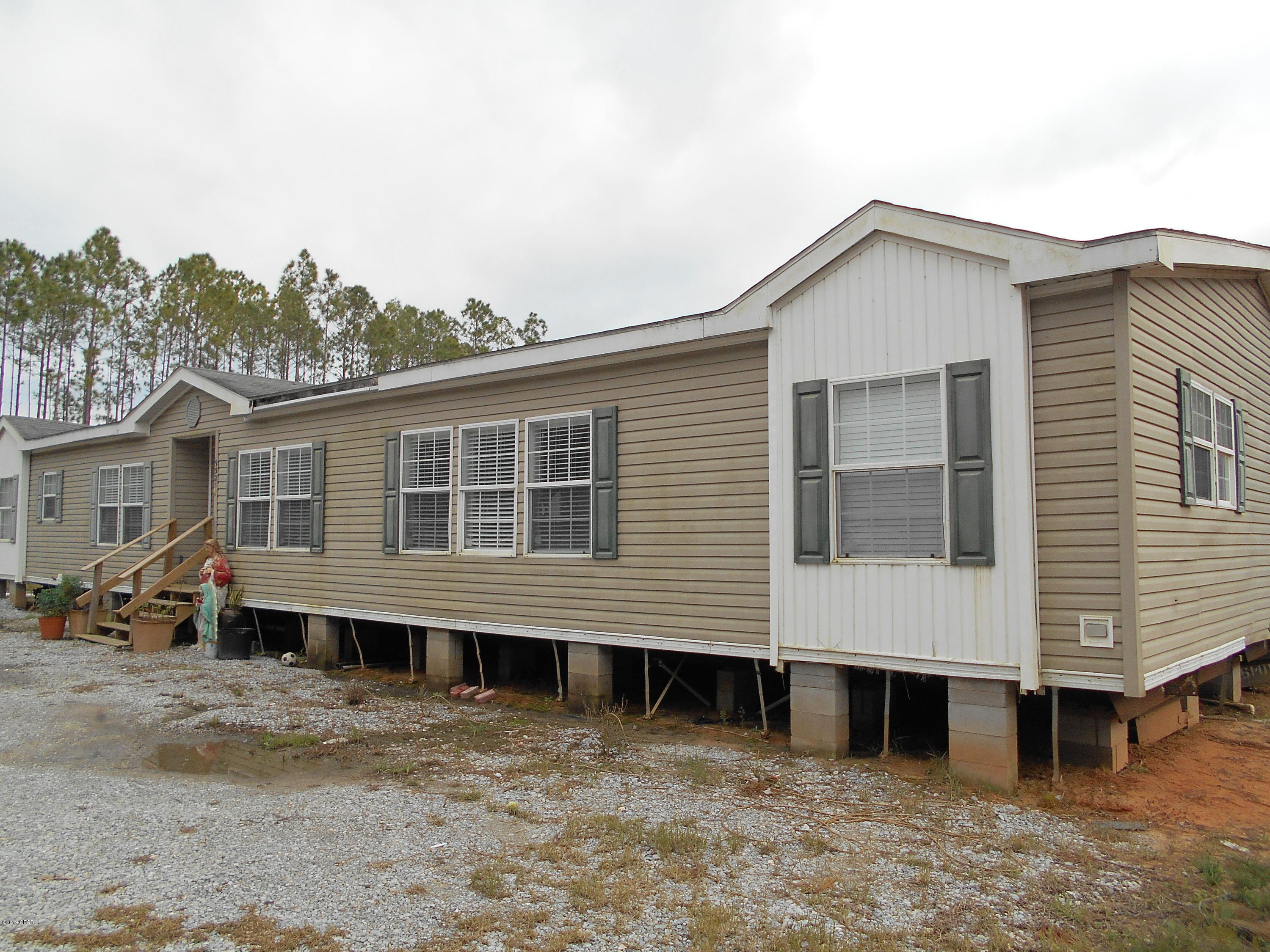 'CURRENTLY UNDER CONTRACT, SELLER ACCEPTING BACKUP OFFERS'  If you need room for horses, or just want some space to spread out, this 16+ acre home site is for you. Only one small trail on site, so this is a blank canvas for you trail riders. Plenty of room for a large home, pool, horses, barn, outside play area, and much more. There's a nice 2006 double wide mobile home with electricity, well, and septic  in place, so you can live here as is, or live here while you build your dream home. The split floor plan offers 4 bedrooms, all with large closets. With lot's of room for the whole clan, you can enjoy time together in the family room, or split up into the living room.  Don't miss this great opportunity to have it all. Home needs a minor amount of TLC.   Shed does not convey. All meas.