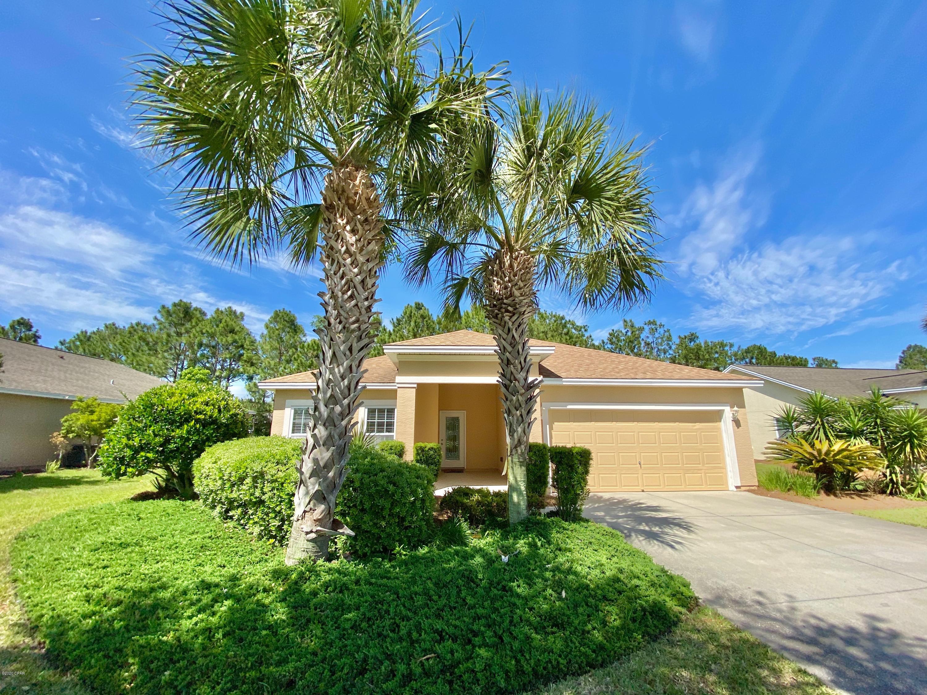 Come see the lowest priced home in all of Palmetto Trace!!!! This 3 bedroom 2 bath home is conveniently located near one of two neighborhood pools, beaches, and pier park.  This home offers recently upgraded nickel light fixtures, wood and terazzo flooring, stainless steel appliances, screened back porch and granite counter tops. VACANT AND EASY TO SHOW IN PERSON OR VIRTUAL!