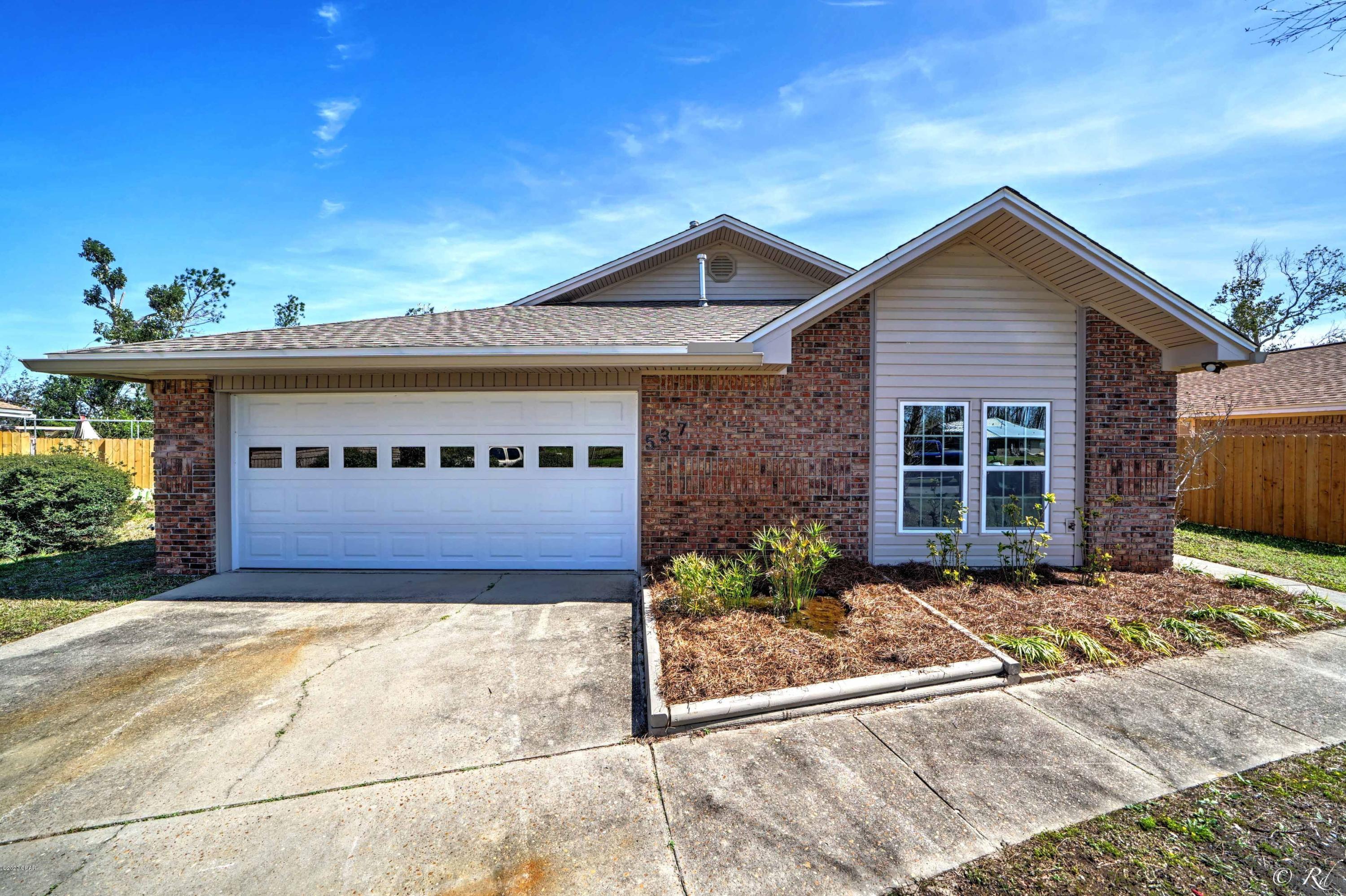 Beautifully remodeled 3 bed/2 bath home in a peaceful, mature neighborhood. This home greets you with vaulted ceilings and a fireplace in the open living/dining room. The kitchen has a breakfast nook and is equipped with stainless appliances, including a double door refrigerator and plenty of cabinet space for storage. This home features a split bedroom floor plan for ultimate privacy. The spacious master bedroom has a large walk in closet and the en suite is dreamy with a double vanity, jetted tub, and a separate tiled shower. The guest bedrooms share a full bathroom with a shower/tub combo and a skylight to let in plenty of natural lighting. One of the guest bedrooms has two closets. The laundry room is located off the garage and also has a pantry/storage closet. There is an enclosed patio off the living room that leads to the large, fenced backyard. The sliding glass doors to the patio are storm glass doors. This home has a new roof, new garage door, and new attic ladder with blown-in insulation. Freshly painted with LVP flooring throughout. This home is located near Tyndall AFB, schools, parks, restaurants, and more.
