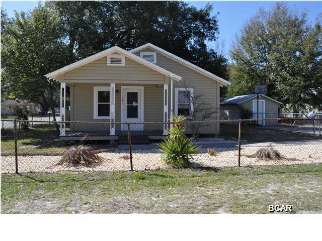 Fantastic starter home right across from a park and only 10 minutes from Tyndall Air Force Base. This 2BR/1BA cottage has been renovated and updated and is move-in ready. In 2014, the sellers added new kitchen appliances and cabinets and installed tile counter tops. The entire home, inside and out has been painted. The wood laminate flooring in the bedrooms is less than a year old and most of the windows have been replaced. The sellers also upgraded the HVAC in 2013. This is an all electric home with public sewer and water, situated on a corner lot. There is also a workshop on the property with lots of shelving and room for your hobbies. The public park across the street has ball fields, tennis courts, a playground and covered picnic tables. You're also less than 5 minutes from  schools, shopping and more! All info is approx. and must be verified by Buyers if important.
