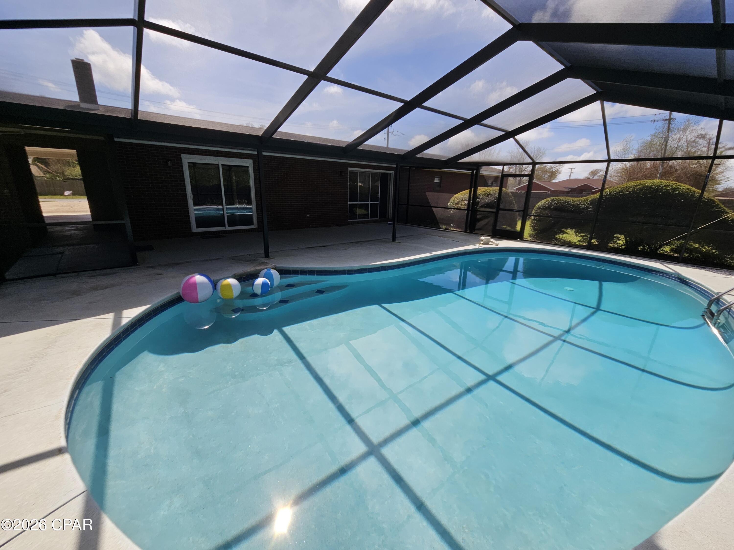 One acre on large corner lot with enclosed swimming pool. Looking for a large house with lots of room and land, this is it. This house offers 3 bedrooms 3 bath with large kitchen and dining area. Family and living rooms with fireplace overlooking the swimming pool. Lot has lots of room for all your toys and includes a yard building and fire pit. Master bedroom has two closets. take your tour & make your offer. If important all information and measurements should be verified.