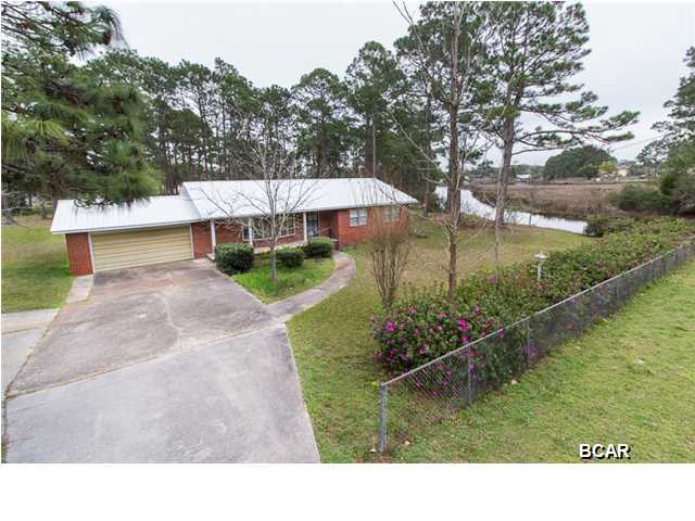 BACK ON THE MARKET.  Buyer’s financing fell through. All inspection were completed and repairs taken care of. Brand new double pane windows were installed throughout the entire home as well. Gulf Access from your own backyard! Less than 5 minutes by boat to the open water. This solid all brick home has a brand new metal roof and a huge yard. Located less than 10 minutes to Tyndall Air Force Base and just minutes to shopping and restaurants. Don't let this amazing deal pass you by. Each room in this home are a great size. The 21x12 dining room opens up to the large Florida room where you have awesome views of your backyard and the bayou.