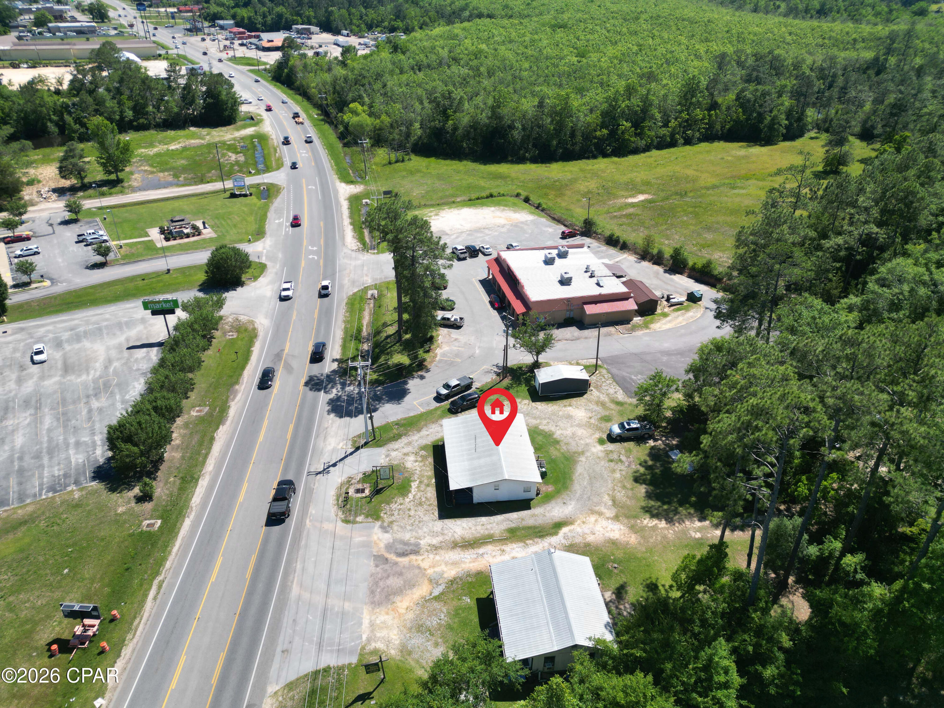Directly in the heart of Bonifay, Florida, this commercial property presents an outstanding  business opportunity with excellent visibility and accessibility! Located just off State Road 79, this 0.33 +/-acre property benefits from steady daily traffic from both locals and visitors traveling through the Florida Panhandle toward Panama City Beach.
The approximately 1,000± square foot building, currently operating as a full-service salon, offers the warm and welcoming character that feels right at home in a close-knit community such as Bonifay. Fully furnished and equipped, the space is ideal for a stylist, business owner, or investor.
Inside, the tastefully designed salon is currently arranged with three stations while still offering plenty of ample space for additional stations and future growth. This offers an excellent opportunity for an owner/operator to generate additional income by renting booths to other stylists.  A welcoming reception area with a built-in desk creates a polished yet comfortable first impression for clients as they enter. 
The building has been well maintained and features a covered front porch that adds to the inviting hometown feel customers appreciate. Parking is available in both the front and rear of the property, creating convenient access for clients and employees alike. In addition, the spacious lot provides room for future expansion, giving a new owner options as business needs grow over time.
Although the property is perfectly suited for salon use, the flexible layout and prime location also lend themselves well to a variety of other business opportunities including a boutique, barber shop, office space, coffee shop, small retail store, or professional services business.
Surrounded by established local businesses--including a restaurant next door and a Dollar General directly across the street--the property enjoys strong daily exposure while still maintaining the charm and familiarity of Bonifay's small-town business community.
Whether you are looking to open a salon, expand an existing business, create booth rental income, or invest in a versatile commercial property with room to grow, this is a unique opportunity in one of Holmes County's most visible commercial locations. Call today for more information or to schedule your private showing!

Key Features:
*Total square footage of business - 1,224
• Prime location in the heart of Bonifay's established business district
• Hair salon setup but ideal for retail, office, or service business use
• Front and rear parking with easy access for customers and employees
• Plenty of room for expansion
• 12' X 24' shed on property offers additional storage
• Excellent opportunity for immediate use or future investment
• Strong visibility off of State Road 79 with steady local and tourist traffic to Panama City Beach