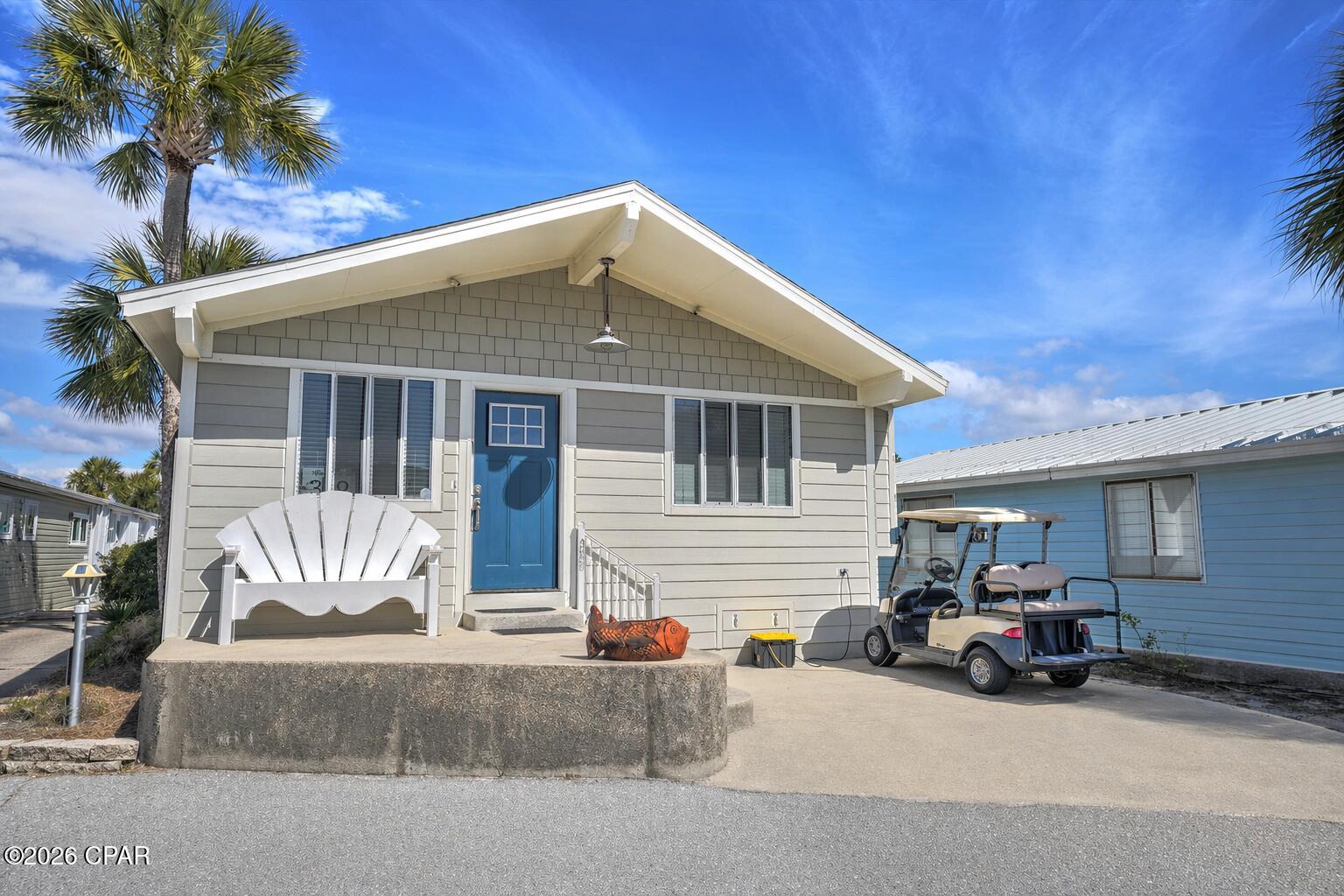 Welcome to your perfect beach getaway in the highly sought-after Venture Out Resort in Panama City Beach! This beautifully maintained 3 bedroom, 2 bath home is being sold fully furnished and includes a golf cart, making it completely turnkey and ready for immediate enjoyment or rental income.

Step inside to a bright and inviting open floor plan featuring durable vinyl plank flooring throughout the main living areas and a light, coastal color palette that creates a relaxed beachy vibe. The spacious living room flows seamlessly into the kitchen, offering plenty of room for family and guests to gather.

The kitchen is well-equipped with ample cabinetry, generous counter space, and everything needed for everyday living or vacation stays. Just off the main living area, you'll find comfortable bedrooms, including a flexible third bedroom that can easily serve as a bunk room or additional guest space.

Enjoy your morning coffee or unwind after a day at the beach in this cozy and welcoming home designed for easy coastal living.

Located in a gated, golf cart-friendly community, Venture Out offers incredible amenities including private beach access, two swimming pools, fishing pier, boat ramp, playground, and 24/7 security. Whether you're looking for a second home, investment property, or full-time residence, this one checks all the boxes.

Don't miss this opportunity to own a turnkey beach home in one of PCB's most popular resort communities!