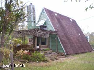 A-Frame home on 10 ac.Paved rd & located just off Hwy 231.Property landscaped w/flowering bushes & many different types of fruit trees. Garden spot w/irrigation. Barn w/fenced area for horse. LG 3 rm storage bldg houses well and washer & dryer, w/work this storage bldg could be turned into a studio apart? LG 3 rm greenhouse w/attached lean-to w/shelves for potted plants. Home has 2 bdrms upstairs & master downstairs. Lots of built in shelves & ceiling fans thru out. Wood burning fireplace and beautiful mahogany & pine wood panels in LR, hallway, bath & back room addition. Back room addition could be used as office or family room. Walk out to back deck. Beautiful sitting areas in front yard, gold fish pond w/views of the flowering bushes. 2 water heaters, one being solar. 2 wells on property. Prop mostly wooded, wet weather creek in back. Being sold AS IS Needs work. CASH ONLY