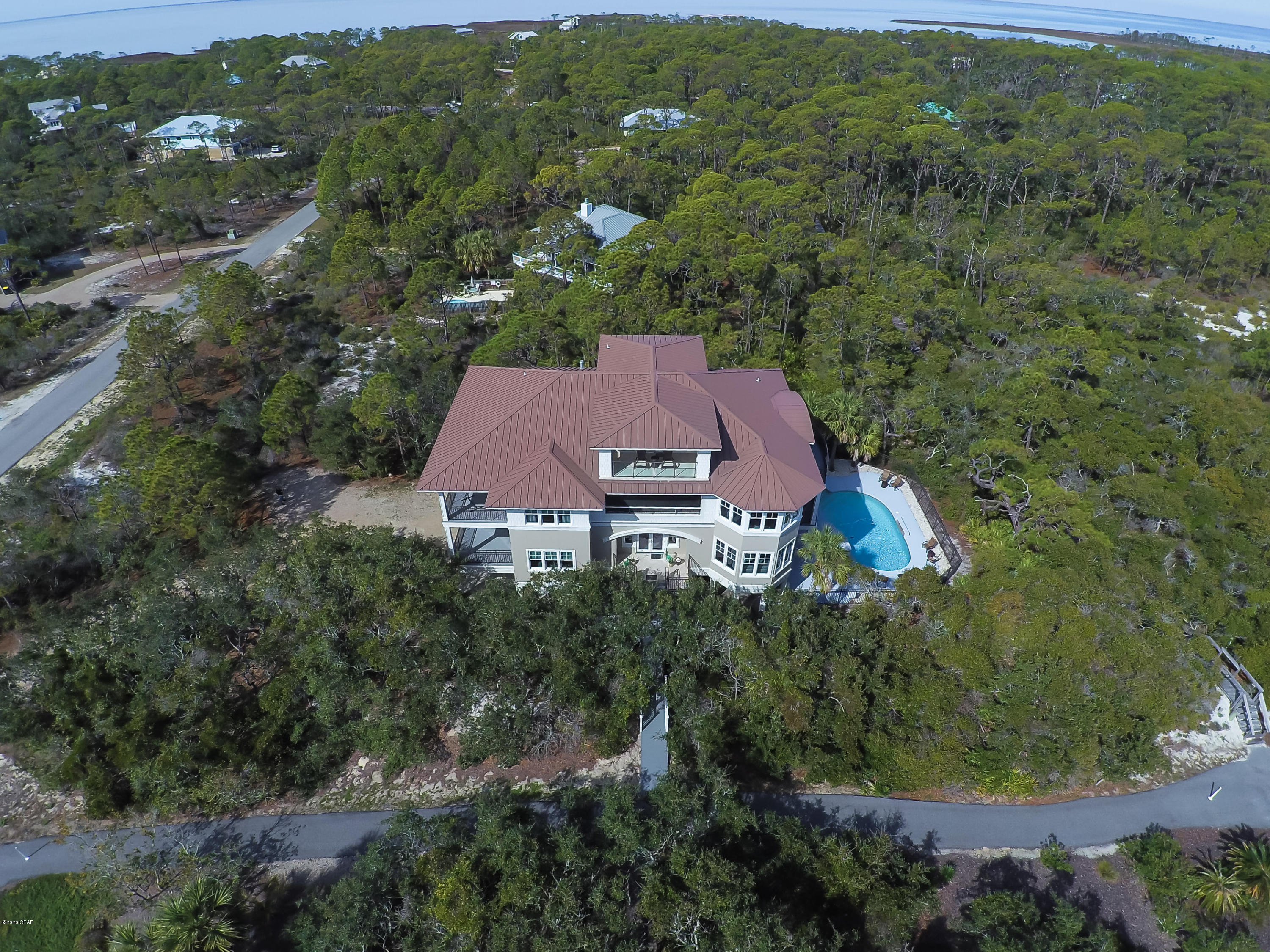 Beautiful and elegant home located on an acre lot in the prestigious and very private Plantation. This home has beautiful gulf views from the third and forth floors, and sits just a short 350 feet from the beach. This home features 7 bedrooms which are stacked for noise control, 8 full baths, and 2 half baths. There are 4 equally appointed master suites; 2 children's suites with built-in bunks, playrooms, and baths.  The master bedroom is located on the 4th floor and can be locked as an owners area as well. There are very spacious living areas on each floor. You can entertain in the home theatre that has stadium seating for 11.  This home comes with 2 kitchens which have granite countertops, lots of cabinet space, and all stainless steel appliances. Large screened porch and a heated pool. This home has been beautifully decorated and conveys fully furnished. There are two laundry rooms, one on 1st floor & one on 2nd. The large oversized pool is heated and has 2 wading pools. Also, there is a full pool bath and a screened porch.  This home is constructed with premium building materials that meet the current hurricane standards for lower insurance costs, super iceane perimeter insulation for lower utility cost, standing seam metal roof, hardiplank & stucco exterior which is more durable and requires less maintenance, 5 zones for efficient heating and cooling, and a multi-zone irrigation system with its own well. This home would make an Excellent rental. All property. All sizes and ages are approximate, please measure and/or verify if important
