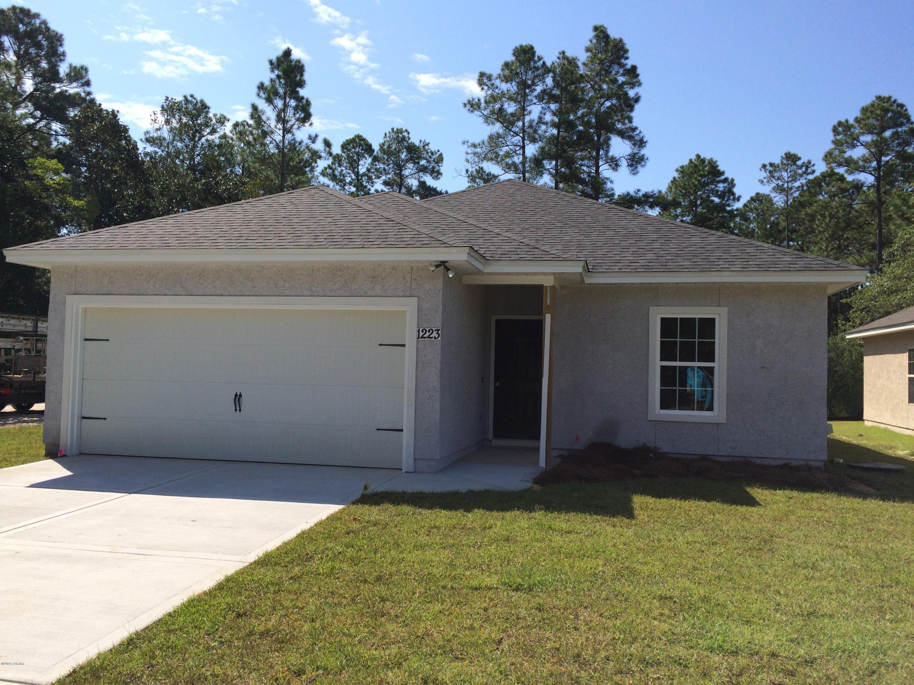 CONSTRUCTION IS NOW COMPLETE...100% FINANCING AVAILABLE ON COMPLETED HOME! NEW CONSTRUCTION IN THE HEART OF LYNN HAVEN. HOME OFFERS LARGE LIVING ROOM/DINING AREA WITH NAFCO FLOORING. THE LIVING ROOM IS SPACIOUS AND OPEN TO THE DINING AND KITCHEN AREAS. THE KITCHEN HAS STAINLESS APPLIANCES AND BREAKFAST BAR. THE MASTER SUITE HAS A LARGE WALK IN CLOSET AND SEPARATE TUB AND SHOWER. EXTERIOR FEATURES INCLUDE, REAR COVER PATIO, TWO CAR GARAGE, FULLY SODDED YARD WITH SPRINKLER SYSTEM AND SIDEWALKS. CALL TODAY TO SCHEDULE YOUR OWN PRIVATE SHOWING APT. CLICK ON PIC FOR ADDITIONAL PHOTOS, VIRTUAL TOUR, AND HOME WEBSITE. ALL AGES, SIZES, AND SCHOOL ZONES ARE APPROXIMATE.LISTING AGENT HAS OWNERSHIP INTEREST IN THIS PROPERTY