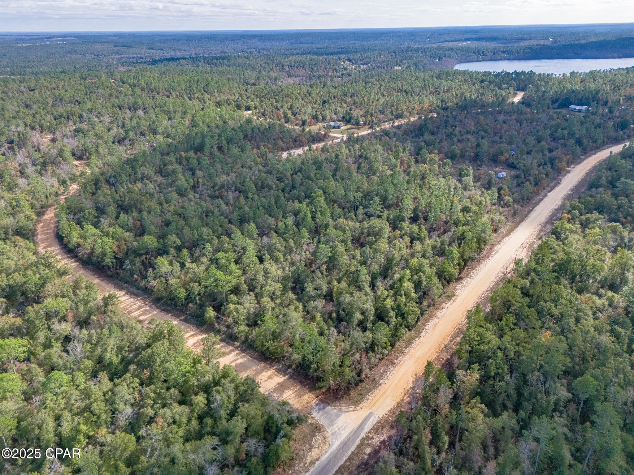 Lake in the Hills community of Jackson County, offering privacy, natural beauty, and a variety of recreational amenities. This spacious parcel provides an excellent opportunity to build your custom home with minimum 1,000 sq. ft. stick-built construction required. 
Compass Lake in the Hills is known for its peaceful, wooded surroundings and access to lakes, boating, fishing, kayaking, a community pool, disk-golf course, driving range, and more. Membership participation is voluntary unless voting rights are desired. 
The community clubhouse is home to Olle's German Restaurant, a local favorite. This property offers the ideal setting for a primary residence, vacation retreat, or quiet getaway--within an amenity-rich community while still enjoying the flexibility of optional HOA membership. Compass Lake is public, yet, McCormick Lake is private and open to only members and their guests. Buyer and agent to perform all due diligence.
