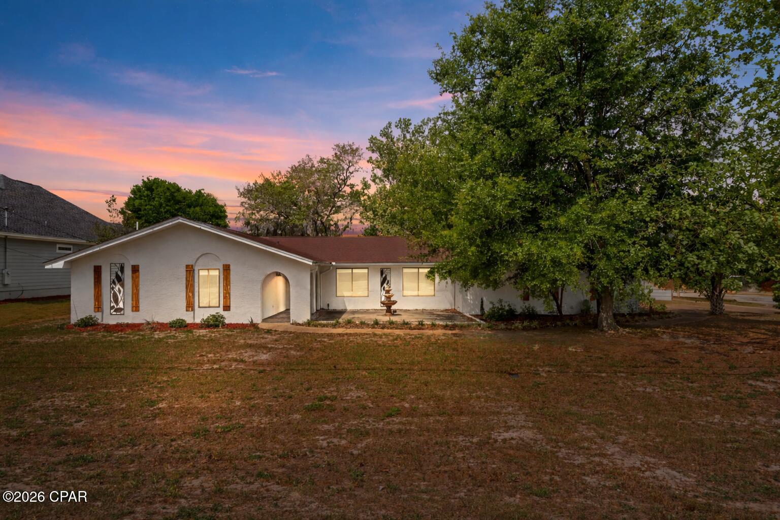 OWNER MUST SELL, PRICED WAY BELOW APPRAISAL Spacious 3-bedroom, 3.5-bath home in desirable Kings Point featuring nearly 2,500 sq. ft., a large office, oversized rooms, and a split-bedroom floor plan. Enjoy a private fenced backyard with a covered patio, pergola, fire pit, hot tub, and workshop. Additional features include a wood-burning fireplace, stainless steel appliances, luxury vinyl plank flooring, an oversized garage, and an updated roof, HVAC, and water heater. Conveniently located near shopping, dining, bay access, and just a short drive to Panama City Beach.