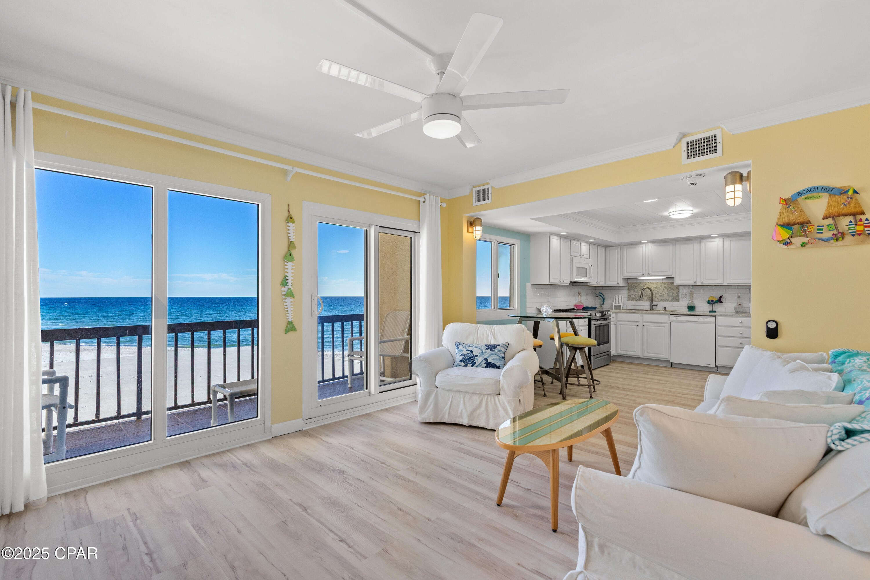 A distinguishing characteristic of this unit is its three balconies, making it one of only two at Pinnacle Port to offer this feature. Conveniently situated on the first (not ground) floor adjacent to the stairwell--with elevator access available--the layout ensures both accessibility and privacy.
This meticulously renovated Gulf-front condominium features three bedrooms and three bathrooms across two levels, offering inviting aesthetics inspired by the sun, sky, sea, and sand. The residence is fully furnished and move-in ready.
Notable interior features include elegant crown molding, distinct ceiling treatments with shiplap detail in the kitchen, recessed lighting, tile backsplash, upgraded cabinetry with solid-surface countertops, ceiling fans, and smooth ceilings throughout. Appliances--including the stove, refrigerator, microwave, and stacked washer/dryer--are less than two years old.  Upgraded bath vanities and fixtures are found in all three bathrooms.
Kitchen and laundry spaces have been thoughtfully redesigned to optimize available floor area. Luxury vinyl plank flooring extends through living areas, with tile present in each bathroom. An open staircase enhances the entry, providing an immediate line of sight to the first level Gulf and Beach and to the upper level while showcasing wood steps.
The main level primary bedroom includes an ensuite bath with a tiled shower, a spacious walk-in closet, and private balcony overlooking the Gulf and beach. The second primary bedroom is located upstairs and offers its own ensuite bath with a tub/shower combination, plus a private balcony with views of the Gulf, beach, and Tower Pool Deck. The third bedroom presents a wall-to-wall window framing the Gulf and beach, complemented by ample closet space for storage and apparel. The third bathroom, situated off the hallway, includes a large walk-in tiled shower.

Pinnacle Port Resort is set on over 25 acres within a secure, gated community, with more than a quarter-mile of beach frontage. Amenities include two swimming pools, tennis courts, sauna/steam room, fitness center, private freshwater dock with boat slips and launch, and complimentary Wi-Fi. Association fees cover electricity for heating, cooling, and hot water; owners are responsible only for a minor electric cost associated with lighting and appliances.