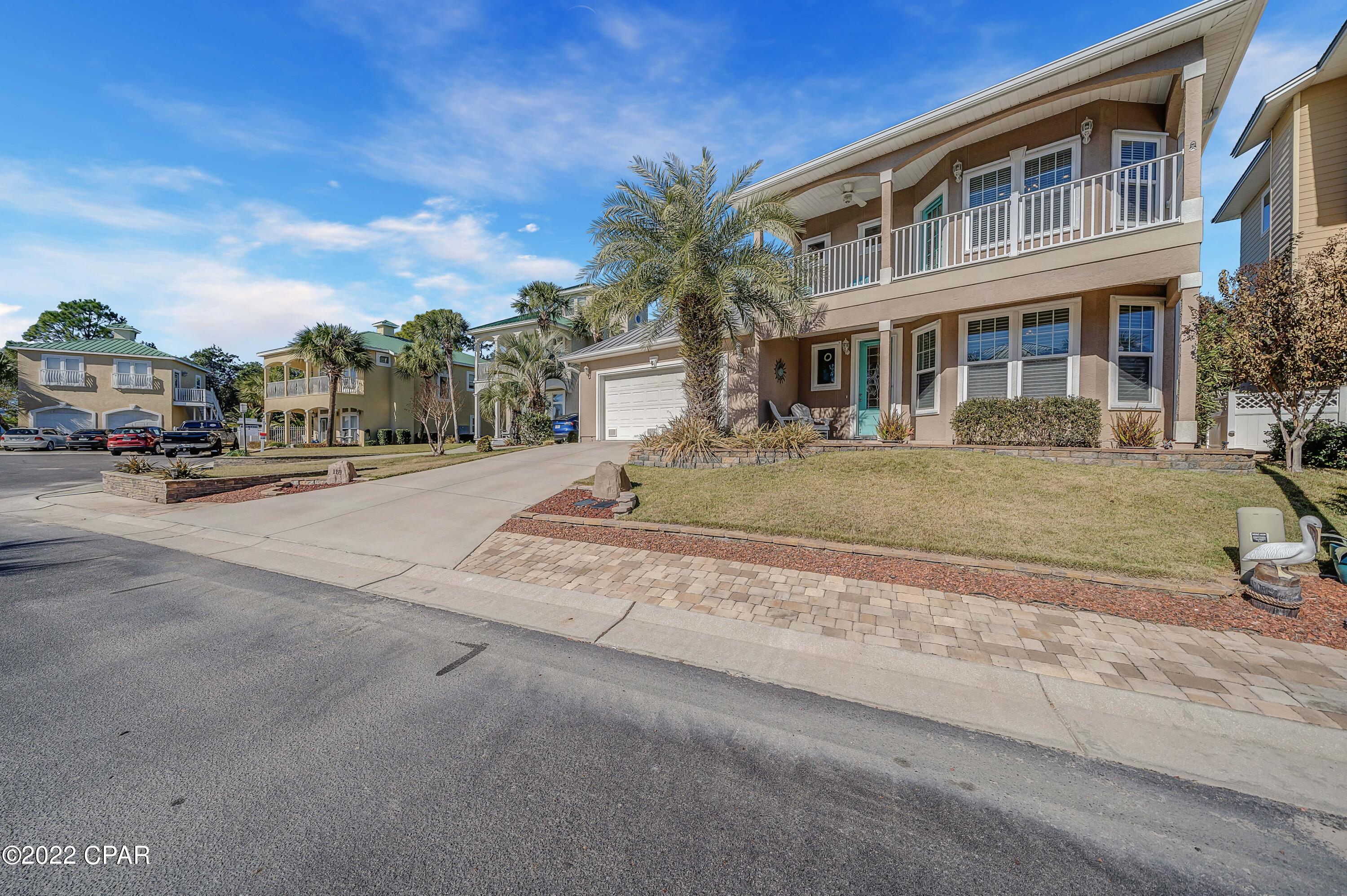 Located in the highly desirable Lakes at Summer Breeze, 118 Smugglers Cove Court is a home that boasts 2,434 square feet, within walking distance of the beach. This unique home has a substantial screened-in

heated pool and hot tub for year-round outdoor fun. There is a master suite and a bedroom on the main floor, and two additional bedrooms upstairs. This home's floor plan lends itself well to modern living,

with ample yard space allowing for an owner to craft a unique indoor and outdoor experience that few homes along the beach can provide. The main floor has an impeccable kitchen and was designed with upgraded stainless appliances including a gas range as well as custom cabinetry with soft close & granite countertops that is open to the living room. Entertaining is a breeze in the lar screen enclosed pool and hot tub with a large brick paver deck for sunning or gathering with friends. The master bedroom is located on the main floor, and the master bath has double vanity with granite countertop, custom cabinets, and a two-person grand shower, with a large walk-in custom closet design. There is another bedroom on the main floor that could also be used for a private home office with an adjacent full bathroom. The second floor presents two generous bedrooms, one with a private balcony. They share a guest bathroom with double vanities, and a sitting area. This is a must-see home, you won't be disappointed.
