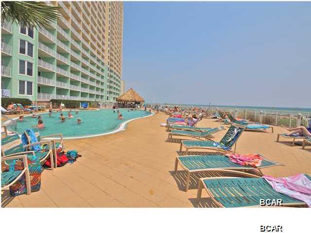 Emerald Beach Resort is one of Panama City Beach's most desirable vacation destinations! This fully furnished 1BR/1BA unit with a bunk area has it all and is priced to sell... Capable of sleeping 6 and just walking distance to Pier Park. This resort provides the finest amenities including swimming pools, hot tubs, tiki bars, an on-site restaurant, a full service Starbuck's, a 10,000 s.f. Convention Center, a 5,000 s.f. Fitness Center with Full Service Day Spa and 8 high speed elevators. The kitchen boasts 3cm granite countertops, track lighting, GE Profile appliances, breakfast bar and under the counter lighting. Other interior features include custom paint, washer & dryer, ceiling fans in living rooms and bedrooms, tile floors in kitchen and bathrooms, cultured marble tubs, and 16' wide 8' double sliding glass doors that open onto balcony and Crown molding.