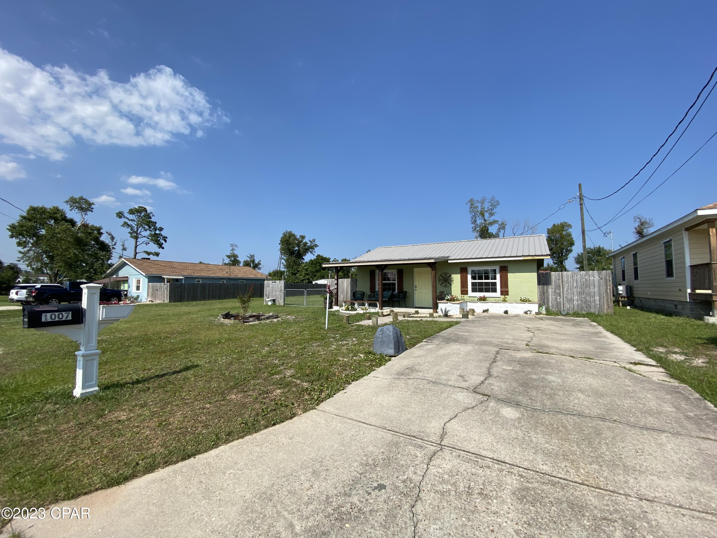 CURRENTLY UNDER CONTRACT, SELLER WILL CONSIDER BACKUP OFFERS - Cute as a bug in a rug.  This home is centrally located in Lynn Haven on oversized double lot.  The 1/3 acre lot has 25x40 shed with two garage doors and 110amp power service.  There is also an RV hookup with water, sewage and 30amp power service.  The home was recently remodeled in 2019 with new metal roof, new windows, new electrical, new plumbing, new 8x15 covered front porch, new hardiboard siding and fresh exterior paint. The kitchen was remodeled with new hickory cabinets, new stainless steel appliances and granite countertops.  The bathroom was updated with new vanity, new fixtures and tiled shower.  There is also a 20x20 area that has been wired and plumbed for an additional bedroom and bathroom to be easily added  Other upgrades include new crown molding, new baseboards, new water heater and shiplap accents throughout the house.  There is a large covered lanai for entertaining.  Home comes with transferable home warranty paid through 2026.  Call to see today!