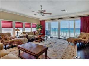 This town home is absolutely stunning inside and the views are even more incredible. Offering 2,230 square feet on two levels with 30 feet of Gulf frontage, this property is truly spectacular. Elevated high on pilings with parking underneath, the views from the living areas are the best around. And the town home only has one common wall so the side offers even more expansive views down the beach. High ceilings, gas fireplace, built-in shelving, custom kitchen w/gas stove, granite counter tops, exquisite glass tile, ebonized hardwood floors, wine cooler, and look how beautifully furnished! The covered decks across the back are huge! It is very difficult to find a property this beautiful and in this price range on the beach. Put this one at the top of your list because you don't want