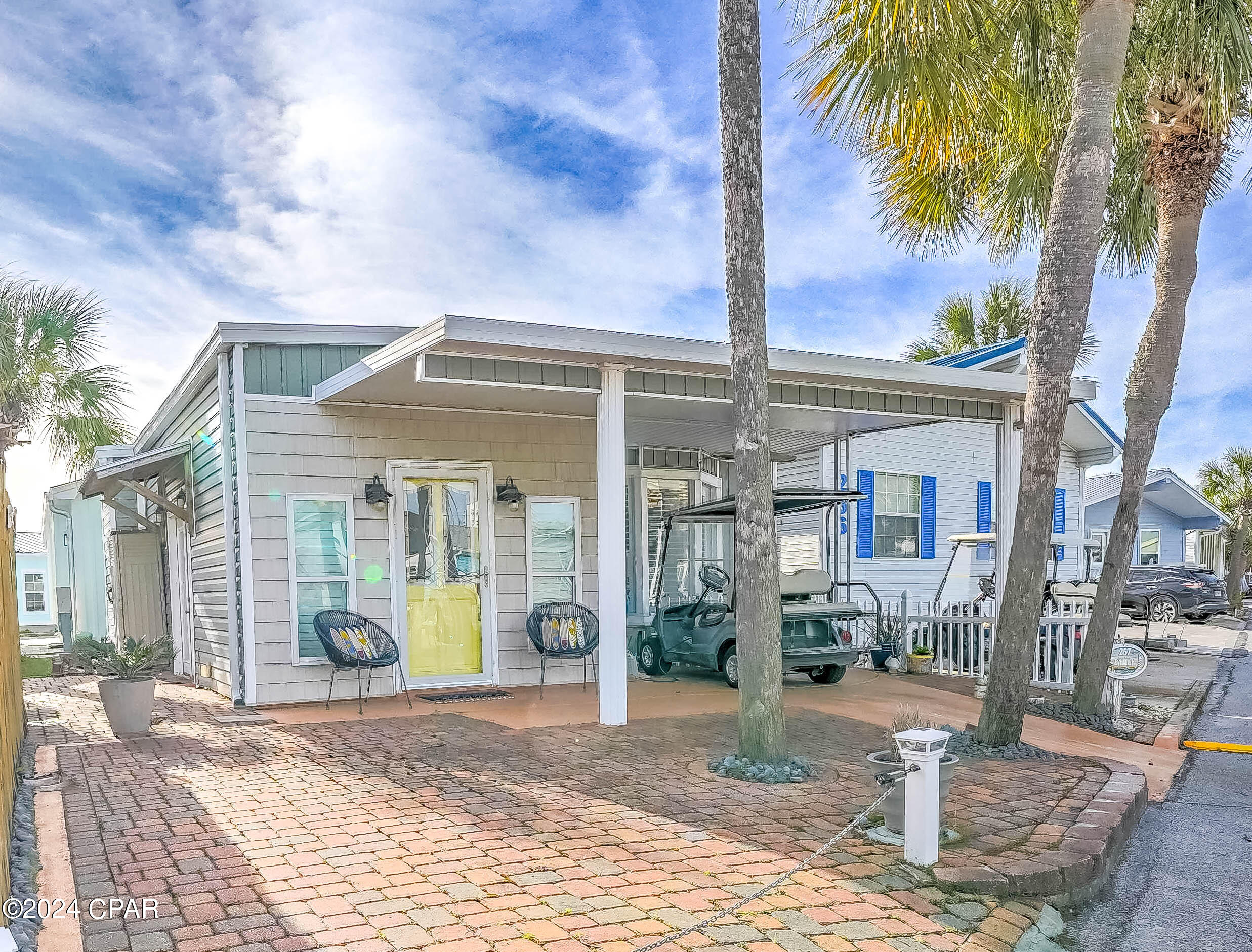 Here's your chance to discover the best of Venture Out! Check out this stunning 2 bedroom, 2 bath charmer. Great living room and large kitchen.  Beautiful wood ceilings throughout and furnished beautifully! New roof in 2018 and HVAC.  You will love the covered patio, nice for relaxing after a long day on the beach! Perfect opportunity for investment or second home.  Venture Out is a golf cart community that has exploded with popularity recently... With 300' on the beautiful pristine beaches of the Gulf of Mexico and 1,000' on the Grand Lagoon. Venture Out has something for everyone.