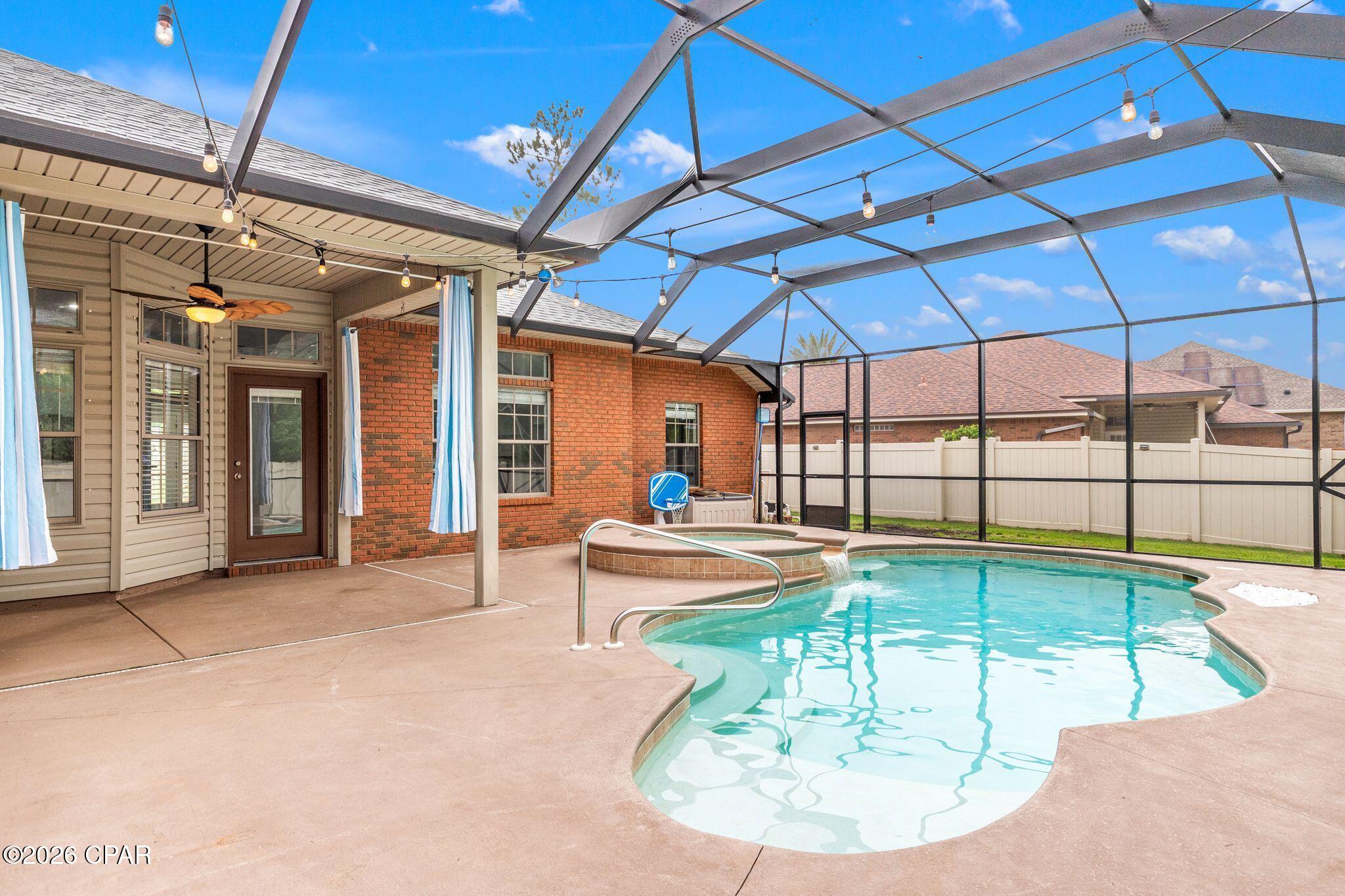 This 4 bedroom, 2 bath brick home in Hawks Landing has been updated with LVP flooring throughout and features 10 foot ceilings, crown molding, built in shelving, and a well appointed kitchen with a breakfast nook. The split floor plan gives the primary suite its own wing with a garden tub, oversized shower, double vanity, and walk in closet, while the three additional bedrooms sit on the opposite end of the home.
The backyard is the real draw. A screened enclosure wraps the heated saltwater pool and hot tub, the yard is fully fenced, and the wooded backdrop delivers the kind of privacy that is hard to come by.
Sidewalks, green space, and convenient access to Tyndall AFB, shopping, and dining make Hawks Landing an easy choice.