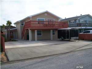 ***New Price***This Water View Home is just across the street from the Gulf of Mexico and Beach Fun! This property was a TOTAL REBUILT-RENOVATION (2013), which was redesigned, and rebuilt back up to this Amazing Beach Home that will be a great Primary Residence, Vacation Rental, or Investment Rental. Listed as a 4 Bedroom / 4 Bathrooms, with an additional bonus room that can be for a home office, dayroom, kid's playroom, and the room can easily convert into a bedroom, making this home a very desirable 5 Bedroom / 4 Bathrooms. This home features two Master Bedrooms, downstairs & upstairs. The owner took great pride in the renovation of this property, and the precision of the workmanship will be apparent when you come to view the home. This home meets all current building codes, and