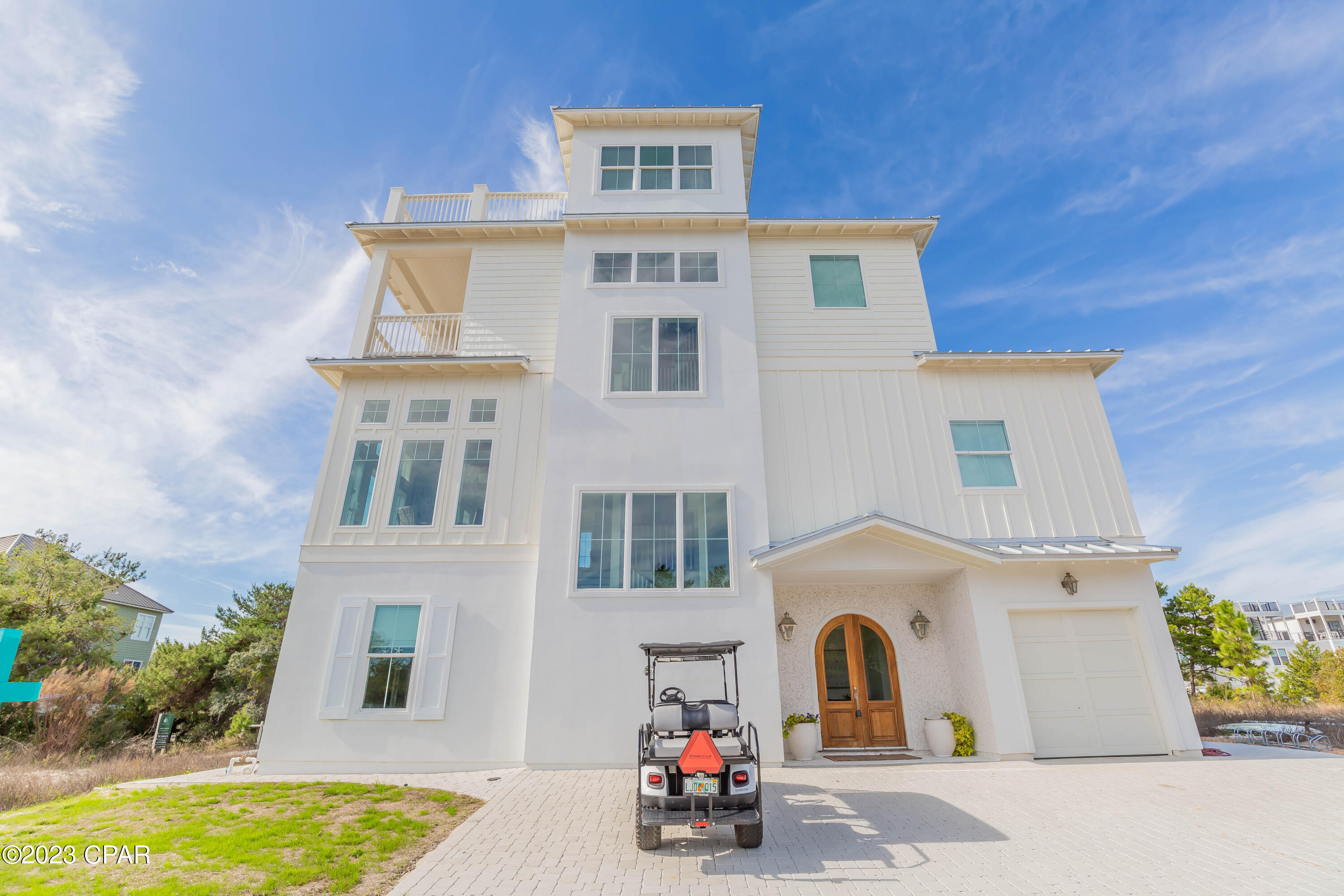 Four floors of indoor and outdoor living space with sweeping gulf views are just the tip of the iceberg at this luxury coastal retreat. It offers more than 1,000 square feet of inviting outdoor living space incorporating a beautiful pool, putting green and multiple porches and balconies providing quiet retreats. The interior design is truly noteworthy having been featured in numerous glossy magazines including Country Living. Custom touches by Truth and Co. interior designers encourage you to linger and admire the characterful mahogany doors and tabby shell stucco fireplace among other features. A glittering chandelier adds a touch of decadence to the formal dining nook. The second-floor sitting room is elegant and spacious with a feature fireplace and sturdy wood beams in the lofty ceiling. Polished wood flooring and multiple sets of windows enhance this delightful gathering space. The open kitchen has a custom L-shaped island topped with veined marble. It incorporates a cushioned bench seat around the dining table. White subway tile walls show off a full range of stainless appliances including a Sub-Zero fridge, Wolf oven and double microwave. Relax on the huge entertaining deck on the third floor which includes a fireplace and TV. It's a place for savoring gentle sea breezes and shimmering gulf vistas, or climb the spiral staircase leading up to the fourth floor for more amazing views. Four bedrooms include bunk rooms, all with ensuite bathrooms. Private balconies, shiplap walls and a vaulted ceiling in the tower room suite add to the individuality of each beautifully stylized room. Master suites on the second and third floors both have garden tubs for relaxing soaks and separate walk-in showers. Outdoors, the white paved terrace and private pool are shaded by palm trees with plenty of space for lounge chairs, barbecues and socializing around the fire pit. This beach paradise is a bike or golf cart ride from Rosemary Beach for fine dining and entertainment. The Big Chill on 30A offers great food and drink, events and lively nightlife. For dreamers, investors and second home owners looking for a home at Inlet Beach that's close to everything, this will exceed your expectations.