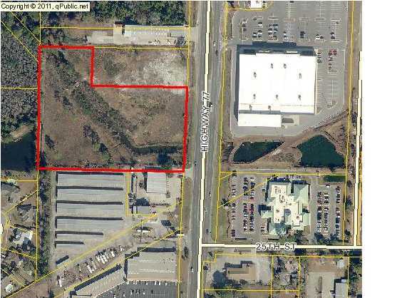 Bank Owned 5.7 acres of vacant land with 350 feet of frontage on Hwy 77 across from Kohl's Department Store. Development opportunity with new joint use drive from Hwy 77 soon under construction by adjacent property owner. Active USACOE and DEP Permits in the file will transfer with deed.