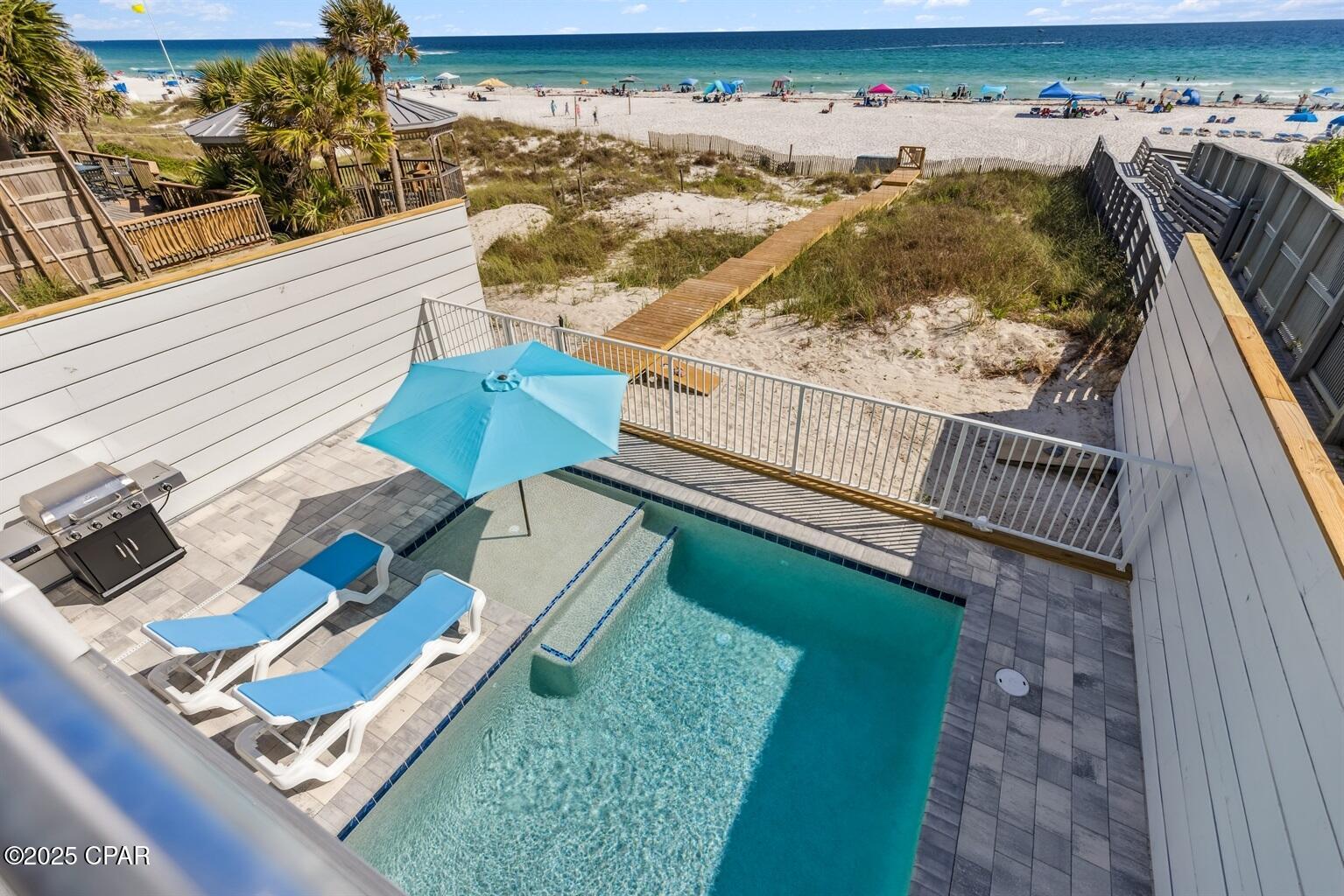 7 bedroom, 8.5 bath Gulf-front beach house in Panama City Beach with a heated private pool, parking for up to 9 vehicles, and no HOA restrictions. Built in 2025 and offered fully furnished, the home combines direct beachfront living, large gathering spaces, and high-end finishes for buyers seeking a luxury second home, private retreat, or income-producing property. The property has more than $200,000 already booked for 2026 and is projected to generate up to $400,000 annually.

The main living area features an approximately 30 x 30 open layout designed for large groups, with Gulf views from nearly every angle. The chef's kitchen is centered around a 10 x 5 island with granite slabs imported from Brazil, dual refrigerators, wraparound seating, and a 75-inch wall-mounted TV. The home also includes 12 smart TVs, a 412-game arcade console, and a third-floor entertainment lounge with space for movie nights, games, a pool table, or air hockey. The primary suite includes 16-foot ceilings, chapel windows overlooking the Gulf, and a private lounge area with a coffee and wine bar.

Freshly styled with more than $150,000 in designer furnishings, accessories, and custom window treatments, the home delivers a turnkey Gulf-front experience. Hurricane-impact windows, a 10-foot sliding glass door, and triple-pane Therma-Tru doors are designed to capture the views while adding protection from coastal weather. A commercial-grade fire suppression system with 24-hour monitoring adds another layer of safety throughout the home and outdoor spaces.

Outdoor living is a major feature, with an approximately 30 x 25 beachfront deck overlooking a heated 12 x 23 Gulf-front pool with an 8 x 6 sun shelf and two heaters. A powder-coated aluminum safety fence helps secure the pool area without blocking the Gulf view, and reinforced balcony railings provide added peace of mind. The lot extends all the way to the wet sand, creating a rare stretch of usable beachfront directly behind the home. There is also room for jet skis and other beach gear.

Seller states this is the first beachfront home on Panama City Beach built on 12 x 12 concrete pilings driven 20 feet deep rather than traditional wood pilings. The exterior also features Hardie Board siding secured with stainless screws and a rust-resistant aluminum roof designed to last 30 years or more. Located minutes from Pier Park and near the soon-to-open Tootsies, Top Golf, and Dolly Parton's Pirates Voyage. Buyer to verify all dimensions, bookings, income projections, and future development timelines.
