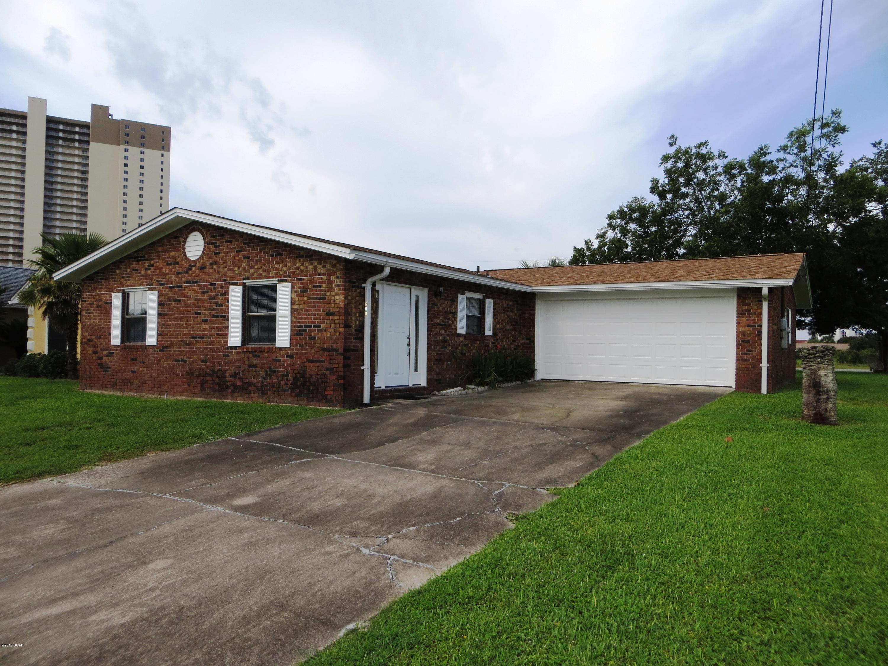 Great 3br 2bt brick home just a tick away from the beaches and Pier Park. The home has a view of Lullwater Lake and the lot borders both Lullwater Dr. and Libson St. 60x146 lot. It has a new roof, A/C, water heater, complete interior overhaul paint, carpet, tile, counters, appliances etc...even the front door is new. The yard has a sprinkler system that is hooked to a well. It is just a great little home nestled in the El Centro Beach area.