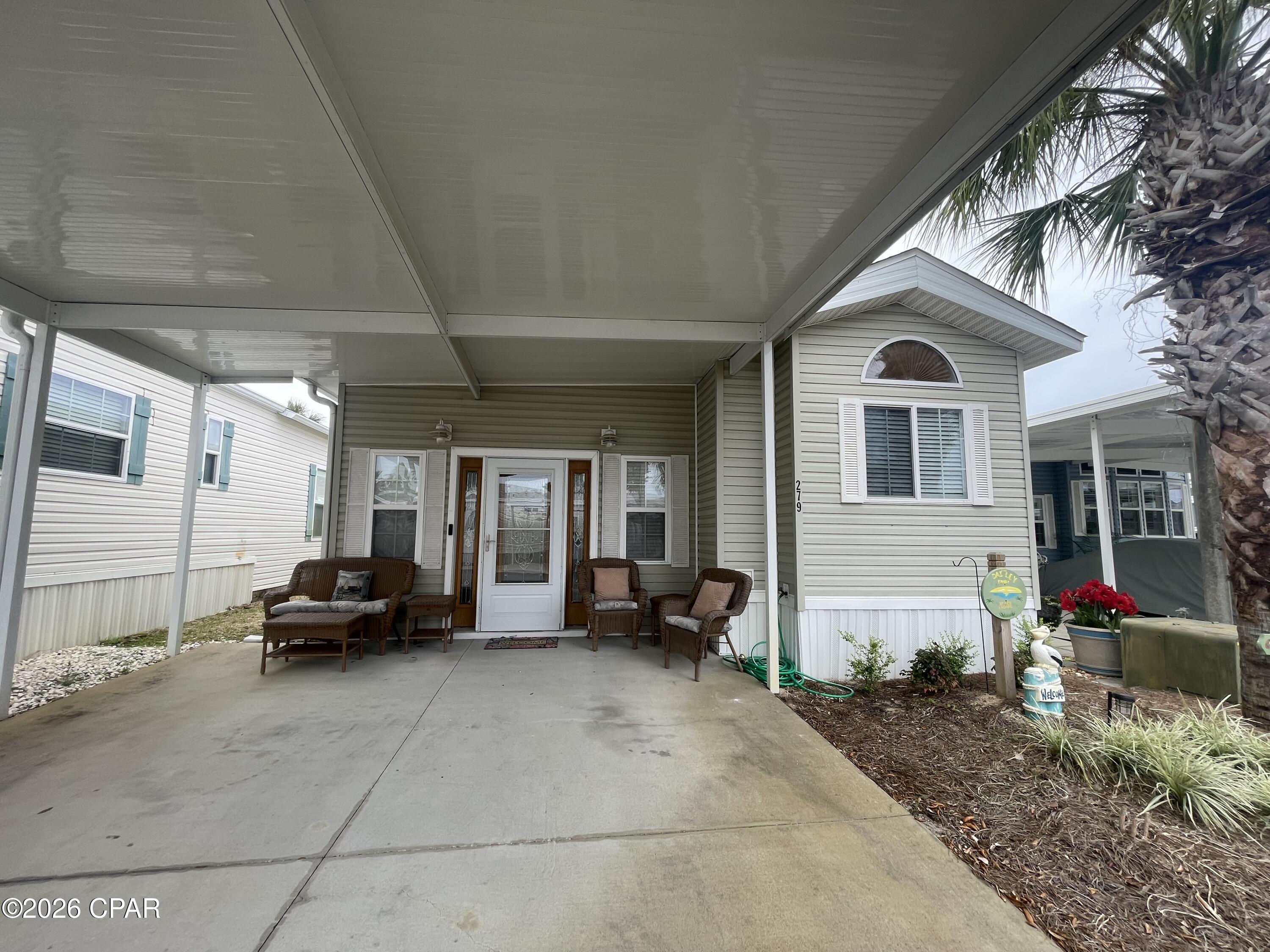 This cute 2 bedroom 2 bath cottage in Emerald Pointe Resort is move in ready, and will be fully furnished with very nice furnishings and décor. It has a large master bedroom, a nice sized living room, an office area, a large sized screened in patio, new LVP flooring throughout, and a 2-car carport. The property also has a storage and laundry room with stackable washer / dryer located in the screened in. Additional updates include: new furniture and decorations 2022, flooring 2022, AC 2019, and hot water heater 2018. Emerald Pointe Resort is a gated community located in the heart of Panama City Beach close to restaurants, shopping, and only 2 miles the world's most beautiful beaches. Amenities include a large clubhouse, exercise room, shared library, 2 pools (one heated seasonally), hot tub, lake with boardwalk, and shuffleboard court. HOA fee includes water, sewer, garbage, new  fiber optic internet, and lawn service. All information is approximate and should be verified by buyer if important.