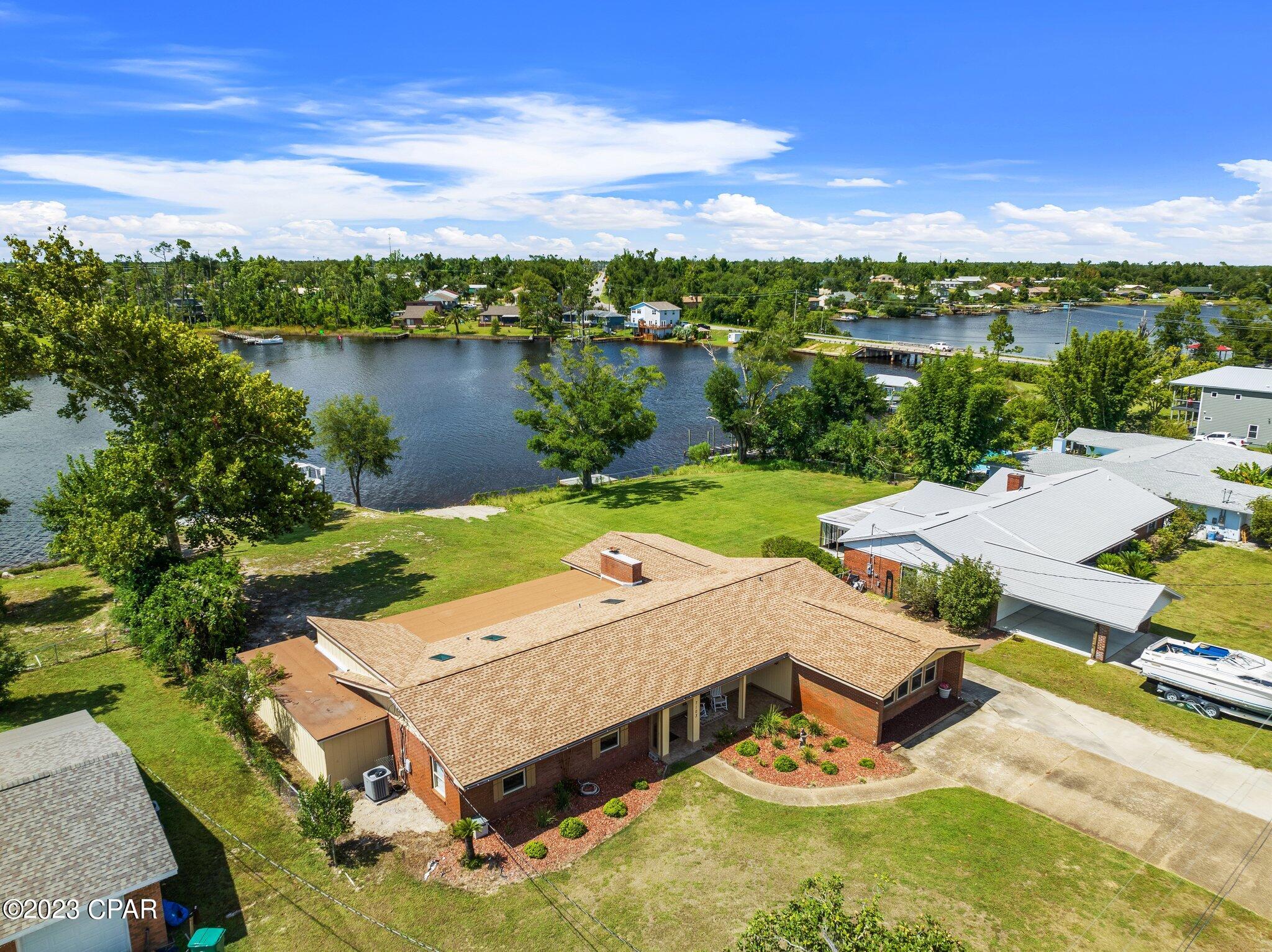 CURRENTLY UNDER CONTRACT, SELLER WILL CONSIDER BACKUP OFFERS**Lovely 4br 2ba, 3,500 sqft Ranch style Waterfront home on Callaway Bayou! Beautifully remodeled with spacious living and kitchen areas all with waterfront views. Open and expansive interior features a gorgeous kitchen with stainless appliances, large granite countertops, and custom cabinets. Home has LVP flooring throughout the kitchen and living rooms. Both living areas are spacious with great views of the water/waterfront. Lots of room for large furniture! Step out of the 2nd living area and down the yard to your boat dock with a boat lift. All new electrical, A/C, and roof replaced right after the hurricane. Callaway Bayou has easy access to St Andrew Bay and the Gulf of Mexico! Home also has easy access to schools, shopping, Panama City and the beautiful beaches of Panama City Beach. Beautiful waterfront home!!!