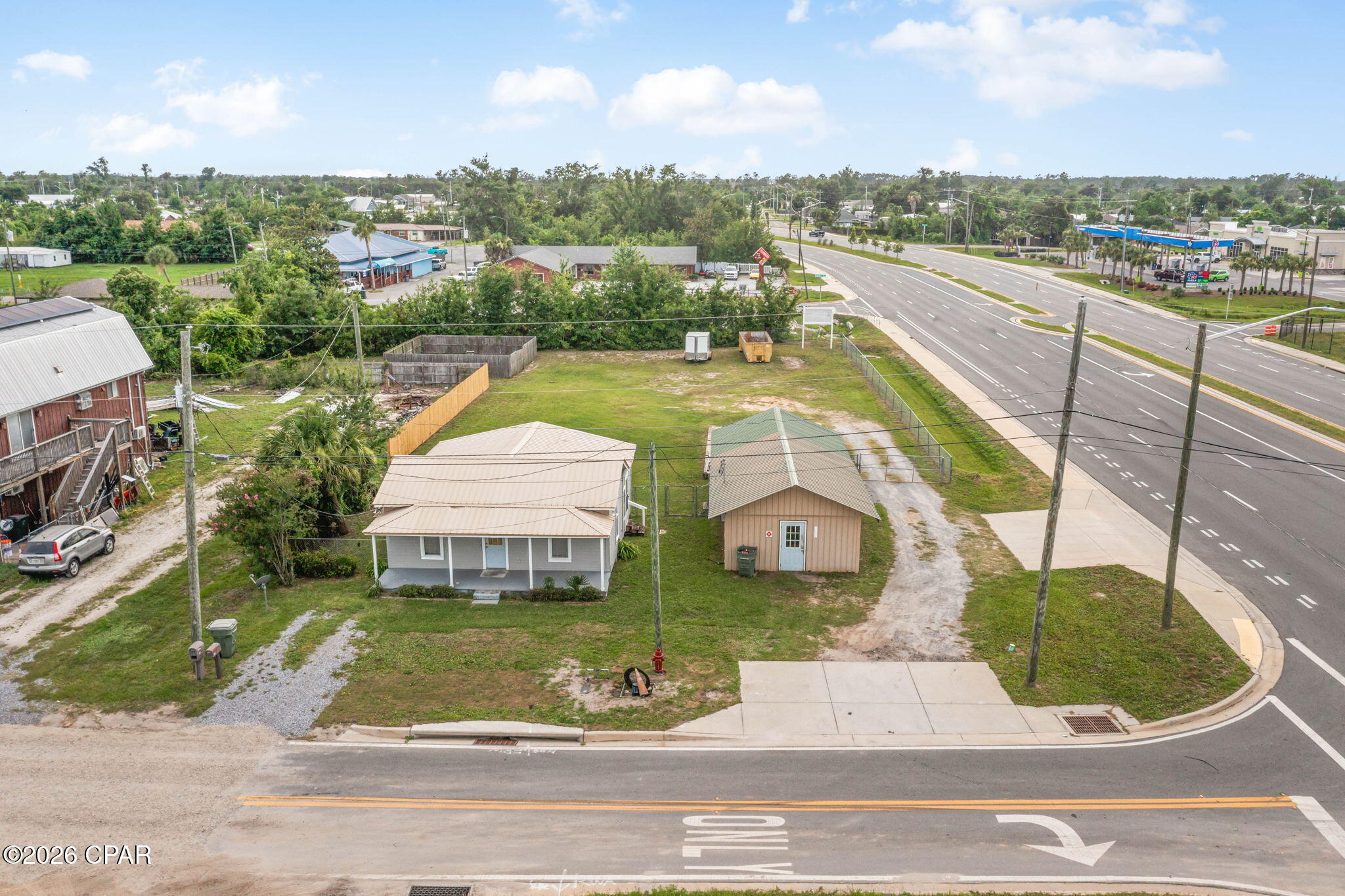 Outstanding mixed-use commercial opportunity located in the heart of Lynn Haven, positioned along the high-growth Hwy 390 corridor. With Hwy 390 now fully complete, this property benefits from exceptional visibility, strong traffic flow, and unmatched exposure in one of Bay County's fastest-expanding commercial areas.

Situated on over one-half acre, this corner parcel offers excellent access from both New York Avenue and Hwy 390, making it ideal for high-demand uses such as a coffee shop, medical or professional offices, retail, or service-based businesses.

The property currently features two existing buildings, historically utilized as both a business and a residence. They are occupied on a month-to-month basis, providing immediate income potential while offering flexibility for redevelopment or repurposing.

Surrounding development continues to accelerate, with the adjacent property featuring a new bank and discussions underway for a Culver's, further enhancing the commercial draw and long-term value of this location.

A rare opportunity to secure a high-exposure site in a thriving market where growth is moving at a rapid pace.