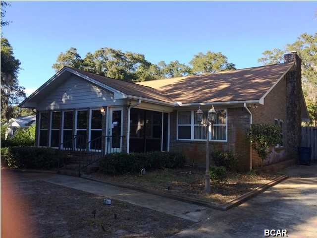 Charming brick home in the desirable Bunkers Cove area. Beautiful tree lined winding street leads you home to this large bungalow with a pool. This home has so many features and has so much potential- a sun room, huge eat in kitchen, living room plus a family room off the kitchen with a fireplace and wet bar, original hardwood floors, a huge master suite and closet. The master bath has both a shower and a tub. Located next to the master suite is the huge laundry room. The laundry room is equipped with a sink and built in cabinets. The large screened patio overlooks the pool and fenced yard.