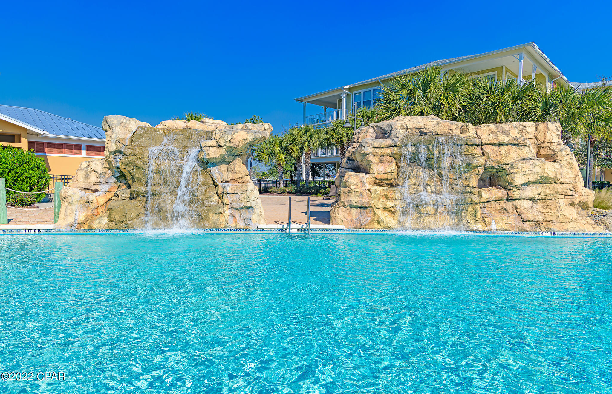 Welcome to the island!  Island Reserve is a gated community with NO SHORT TERM RENTALS.  Sellers will long term rent minimum 6 months and 1 day (no pets).   Located just minutes to the beautiful white sandy beaches, this well kept secret has a laid back lifestyle and endless amenities.  Enjoy the zero-entry acre island pool, hot tub, state-of-the-art fitness center, movie theater room, indoor pickle ball court/basketball court and a nice community room including a pool table.  Bring your golf cart too!  Fantastic location convenient to restaurants and shopping!  Drive right up to the second floor parking garage and you will be steps away from your condo.  Upon entering the unique foyer area, you will love how it opens into the living/dining area and kitchen.  Great for entertaining.  The kitchen offers an island bar, granite countertops, undercounter lighting, newer stainless steel appliances, and newer upgraded light fixtures.  This gem has crown molding in the living room, 10 foot ceilings, ample storage, and newer 4-inch custom plantation shutters throughout.   Beautiful Luxury Vinyl Plank flooring in living/dining areas, bedrooms, and closets.  Tile in baths, kitchen and foyer.  The washer and dryer is also included with the condo.  New water heater.  Enjoy two master suites that boast their own private access to the relaxing balcony.  Each bedroom also has walk-in closets.  One of the bathrooms has a large bathtub and separate shower while the other bathroom just has a shower and lot's of storage space.  There is also a half bath off the foyer for guests.  At Island Reserve you can get outside and walk through the courtyards while enjoying various fountains and beautiful lush landscaping throughout the property.  Come to ''the island''!  Don't miss your slice of paradise.