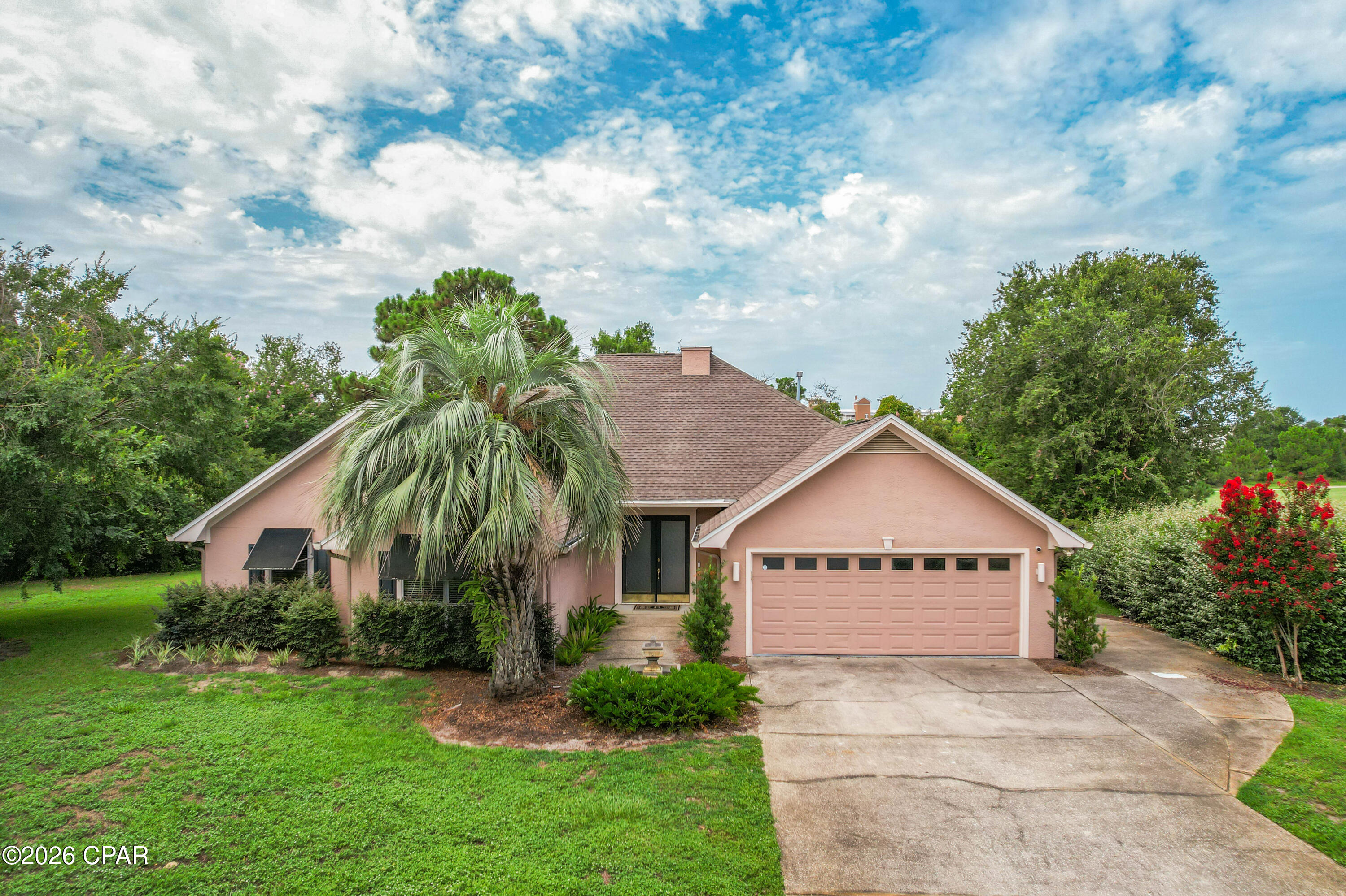 Tucked away on a private cul-de-sac in the desirable Legend Hills neighborhood of Bay Point, this 3 bedroom, 2.5 bath home offers peaceful golf course living. Set along the 14th tee box, this beautifully situated home offers a large homesite with a spacious side yard, mature trees, and a tranquil setting that feels both open and private. Inside, you'll find tall 12' ceilings, crown moulding, and a thoughtfully designed floor plan featuring a formal dining room and an inviting living area centered around a beautiful fireplace. The spacious primary suite with vaulted ceilings is complete with an ensuite bathroom featuring a double vanity, dedicated beauty vanity, oversized walk-in shower with a rainfall shower head, and a custom walk-in closet with built-in storage. Surrounded by mature trees, the oversized cul-de-sac homesite offers exceptional privacy. A huge side yard provides plenty of room to relax, play, or create your own outdoor oasis. The expansive back deck is both covered and open, is the perfect place to entertain guests or unwind while taking in the tranquil surroundings. Additional highlights include an oversized 2-car garage with golf cart door entry, offering convenient access to the golf course and community amenities. Residents of Bay Point enjoy the security of a gated community with 24-hour security, while being just minutes from Point South Marina, Bay Point Golf Club, waterfront dining, shopping, and some of Panama City Beach's best restaurants. Bay Point Golf Club is the only Nicklaus Design golf course in Northwest Florida. With 18 holes of Championship Golf, Bay Point Golf Club is one of the top resort destinations along the Emerald Coast. Combining privacy, generous outdoor space, and an unbeatable location, this home offers an exceptional opportunity to enjoy the Bay Point lifestyle. AC 2025. Gas water heater is new. Buyer to verify any information deemed important.