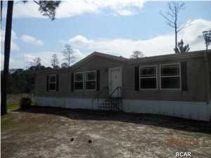 This is a Double wide Mobile home situated on 2 acres of land. Split floor plan with large eat in kitchen. Laundry room with access to the back yard. Needs some TLC. Outside A/C unit is gone as well as the well pump. Master bedroom has private bath with separate shower and garden tub and double vanity. Call today for an appt. Just reduced 4/29/2015.